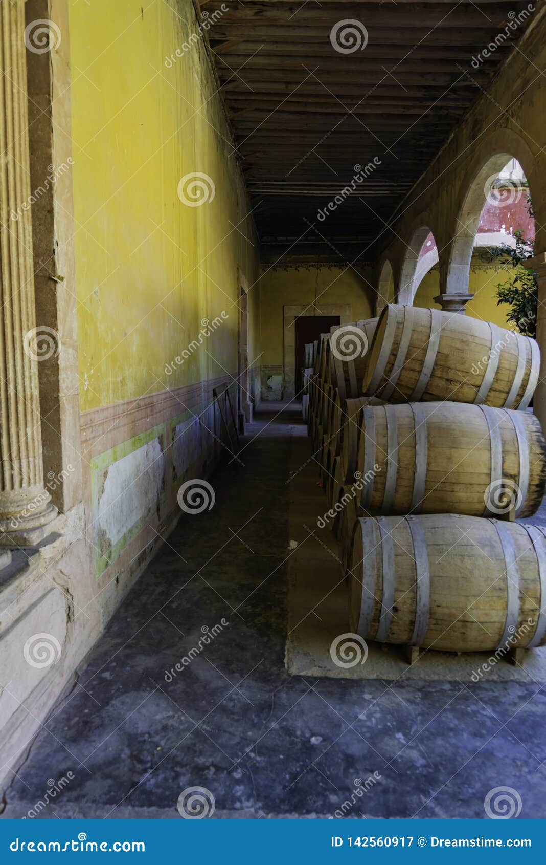 stack of mezcal barrels on yellow wall