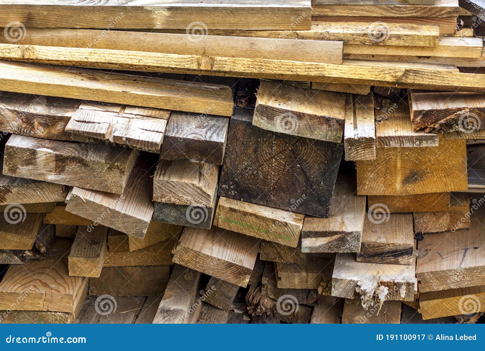 A Stack of Old and Damp Boards. Boards for Construction Work are in a