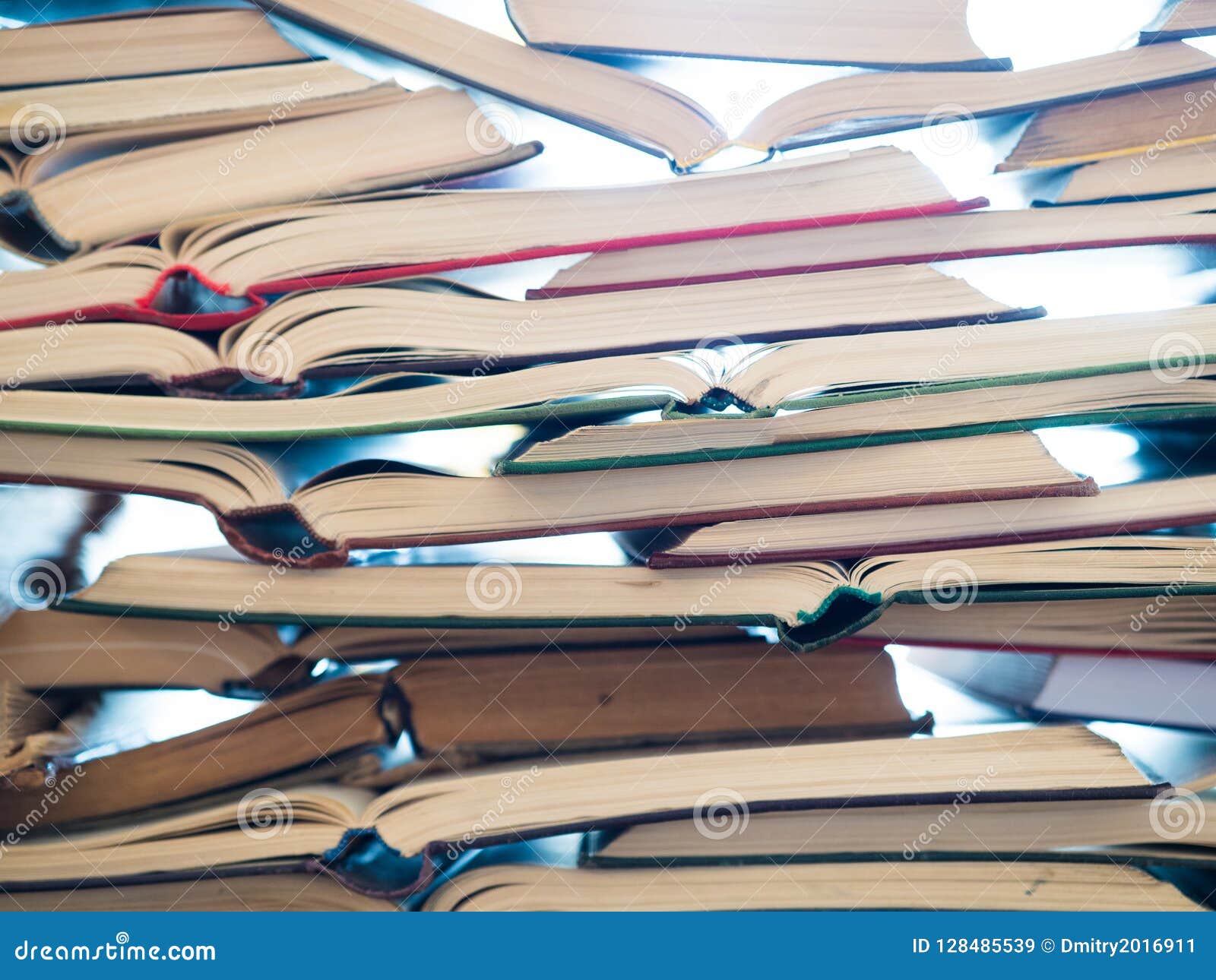a stack of opened book, lying on the table. knowlege and education concept.