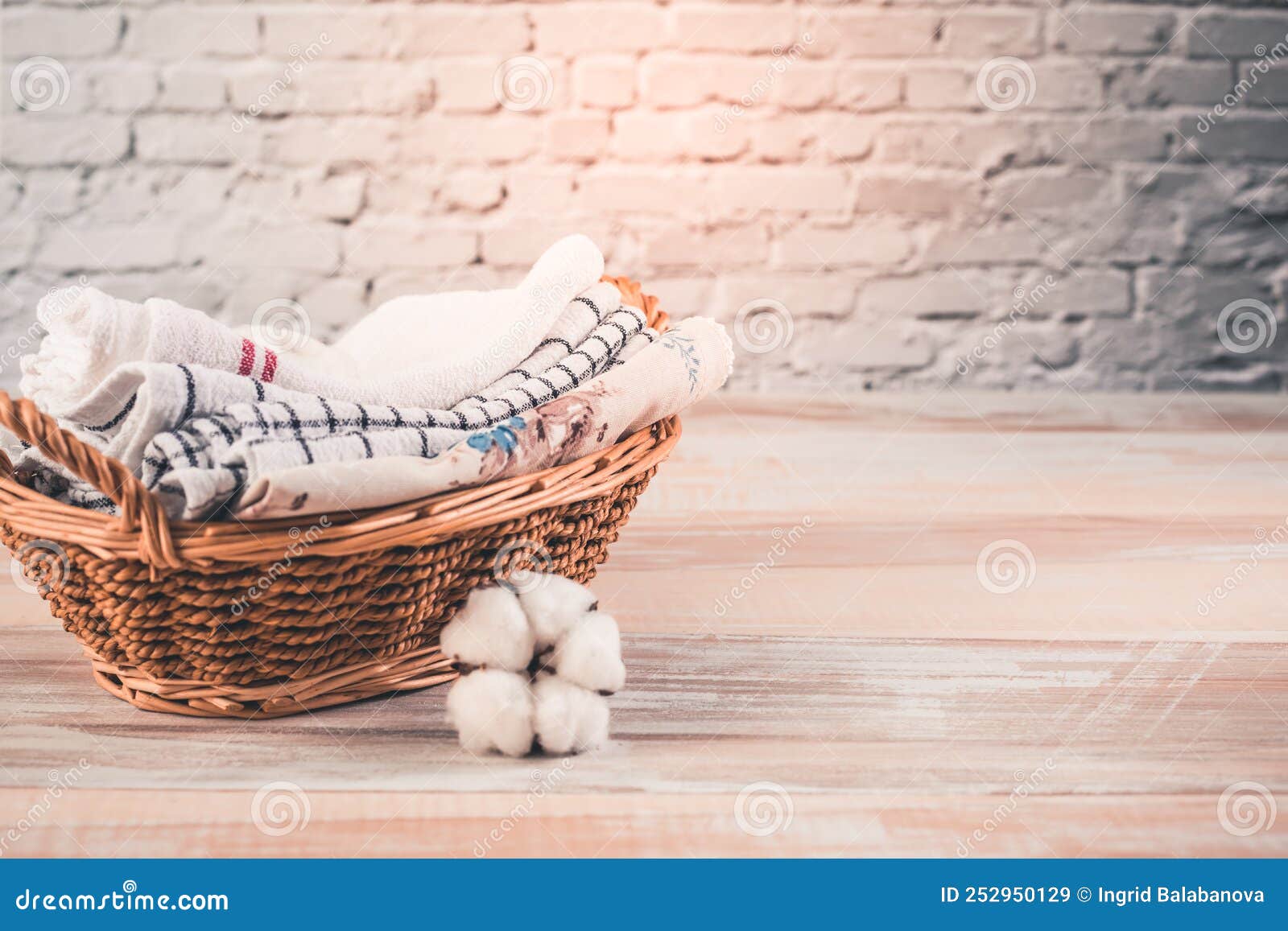 A Stack of Organic Kitchen Towels in a Basket with Cotton Flower. Concept of Sustainability
