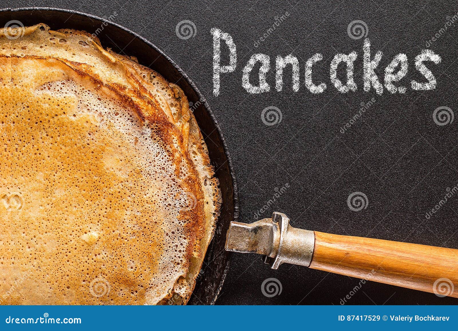Stack of Pancakes on a Castiron Frying Pan and Chalkboard Stock Image