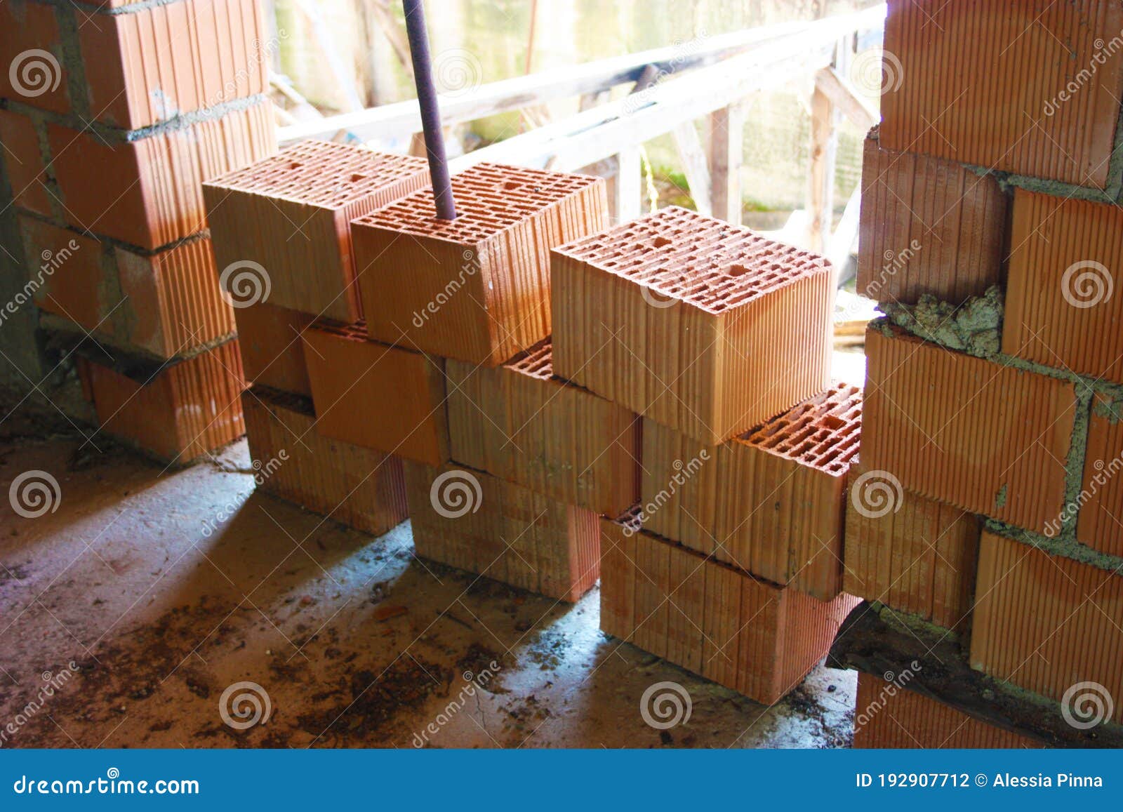 A Stack of Red Bricks To Build a House within the Structure Stock Photo