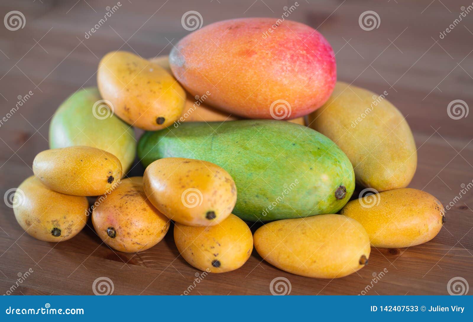 Stack of Several Varieties of Mangos of Different Size and Colors Stock