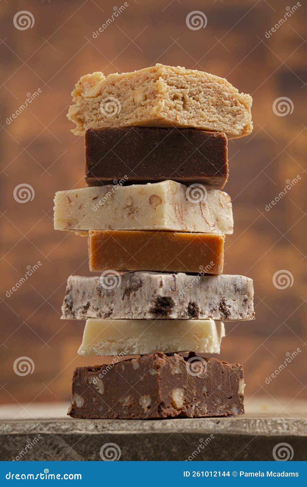 Stack of Six Different Types of Fudge with a Wooden Background Stock
