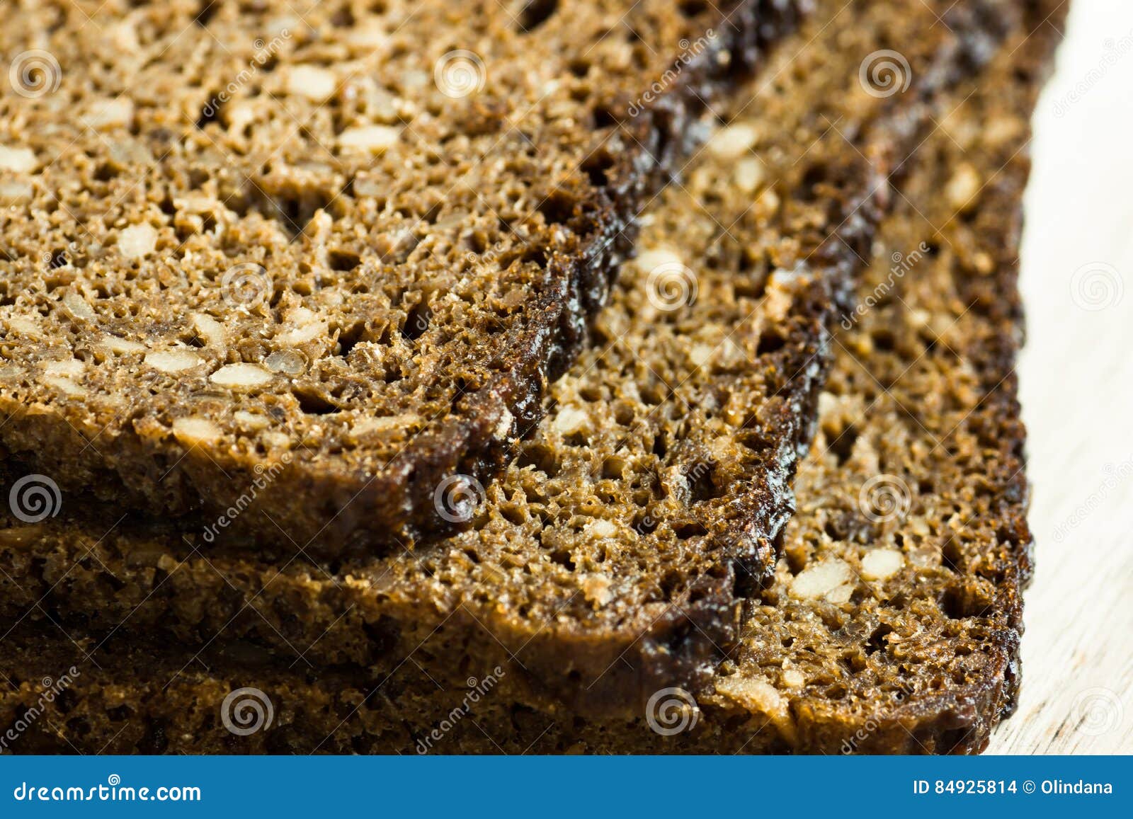 Stack of Slices of Wholemeal Rye Bread with Seeds, Close Up Stock Photo