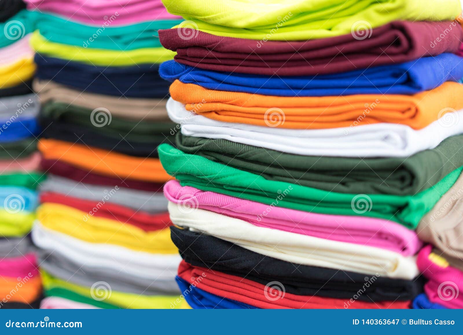 Stack T-shirts on Shelf in a Shop Stock Image - Image of colorful