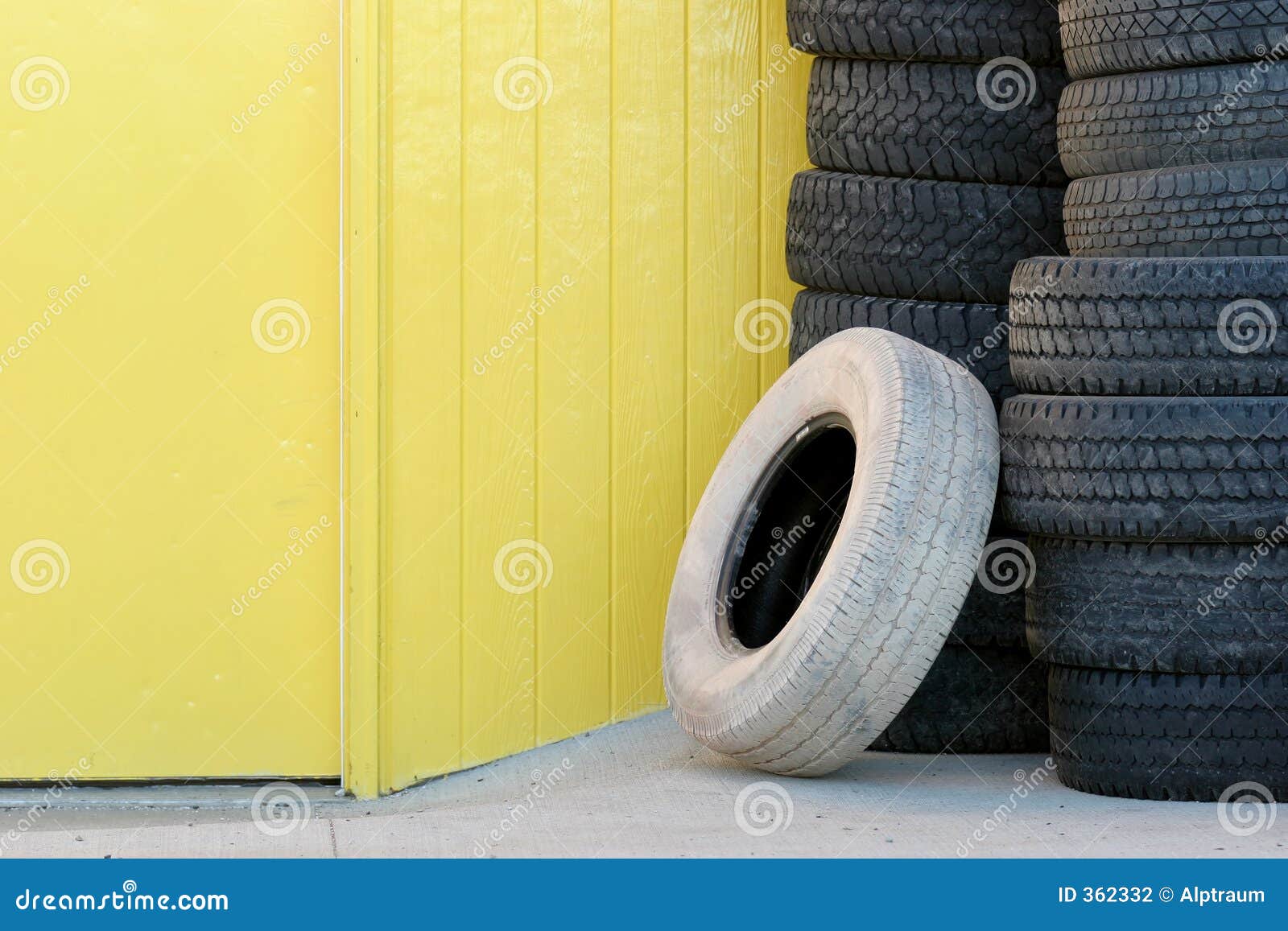 Stack of Tires Against Yellow Wall Stock Photo Image of tire, flat