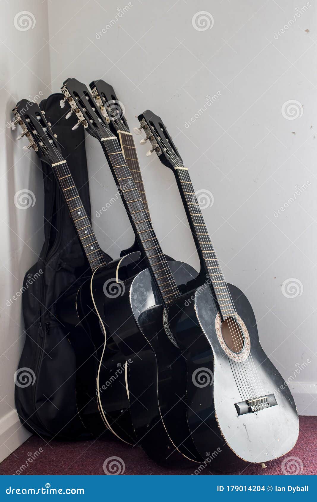 Stack of Used Classical Acoustic Guitars in Storage Stock Photo Image