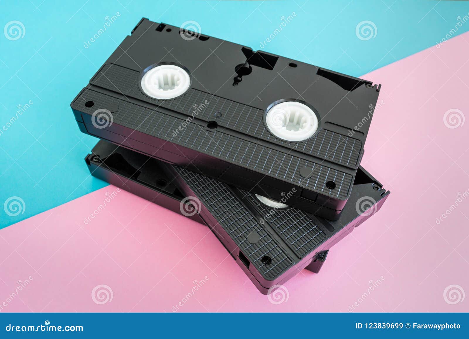 Stack of 3 VHS Tapes on Pink and Blue Background. Stock Image Image of video, background