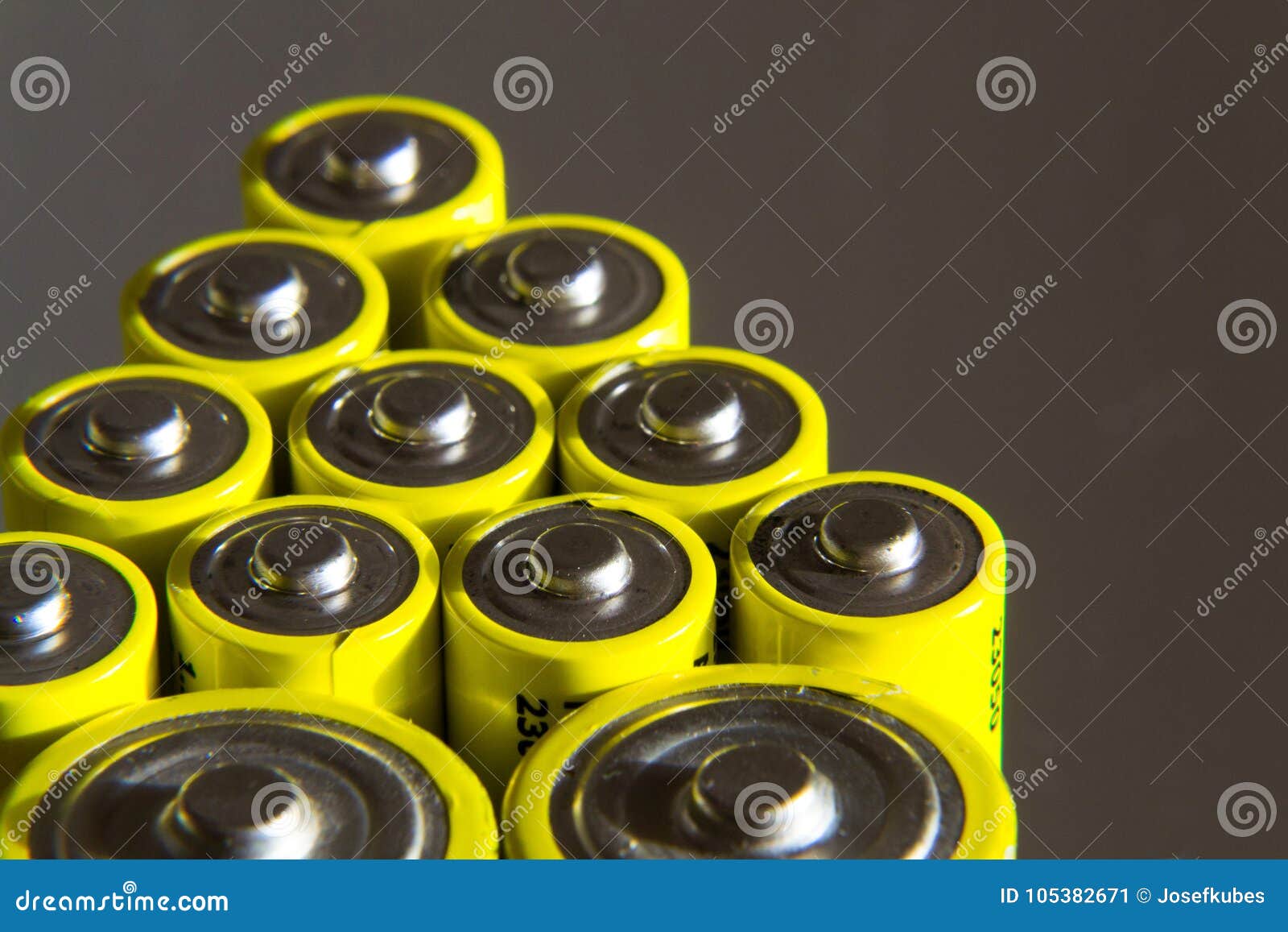 Stack of Yellow AA Batteries Close Up, Electricity Storage Concept