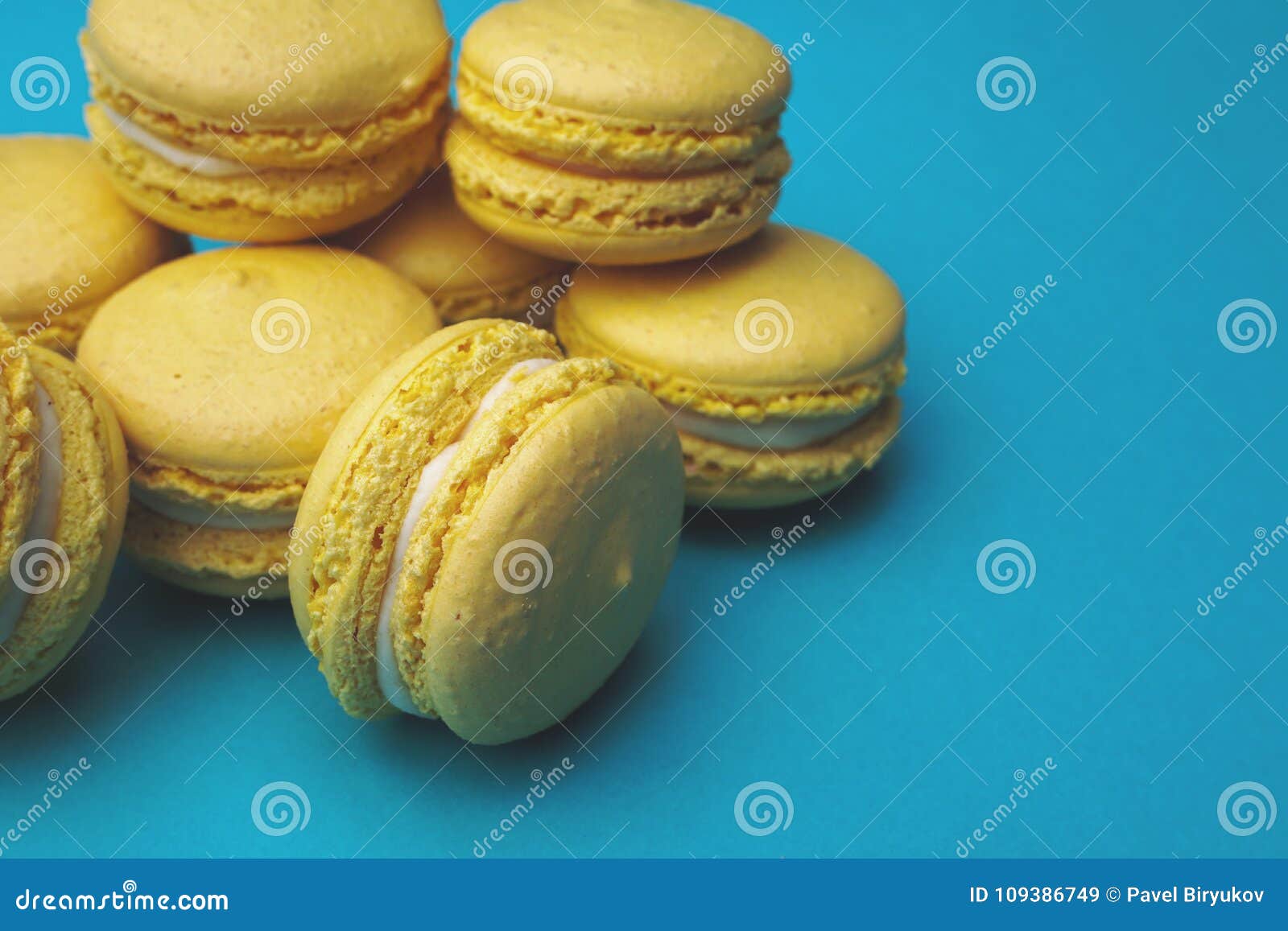 Stack of Yellow Macaroons on Blue Background. Stock Image - Image of ...