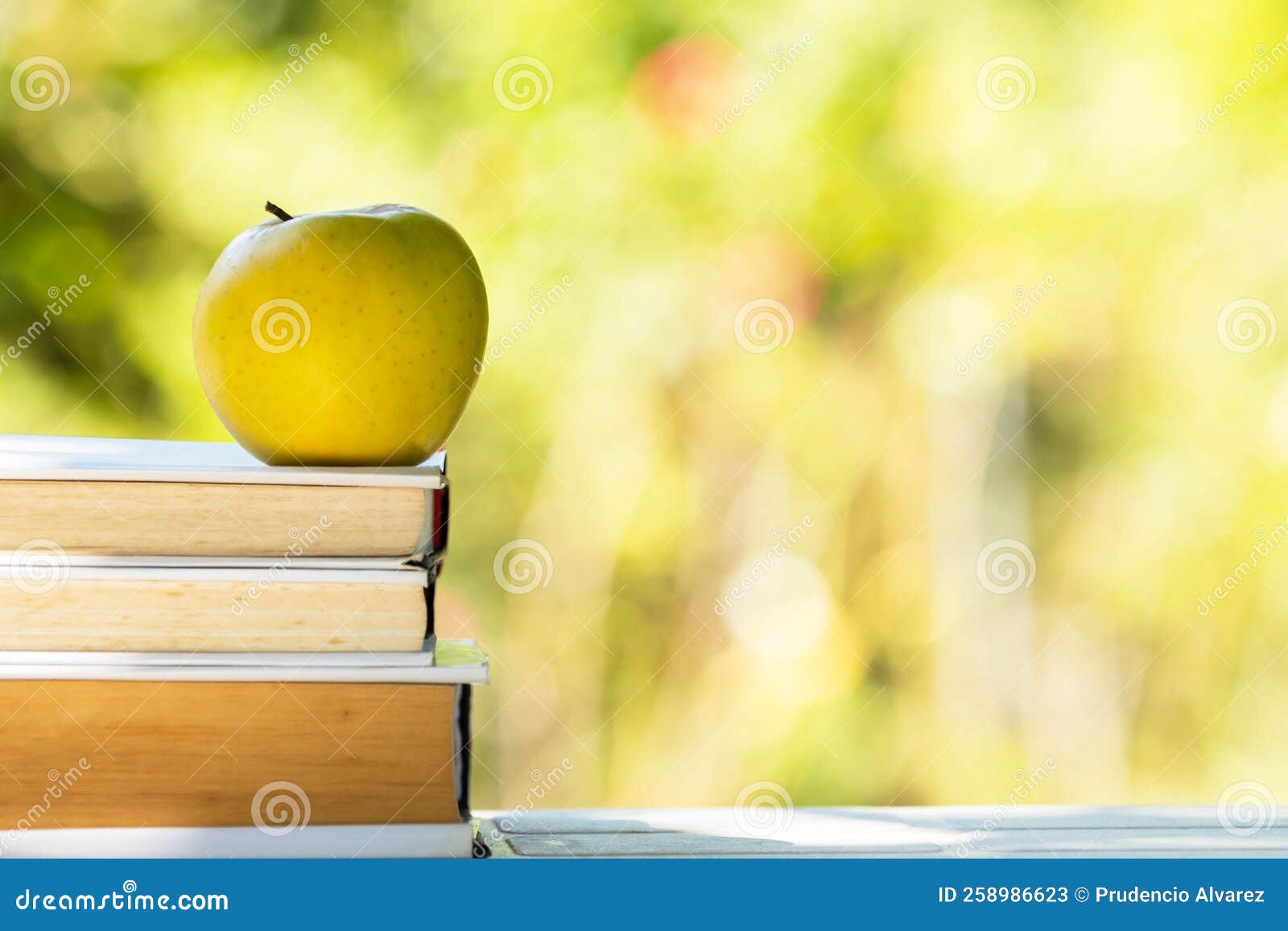 Stacked books with apple stock image. Image of books 258986623