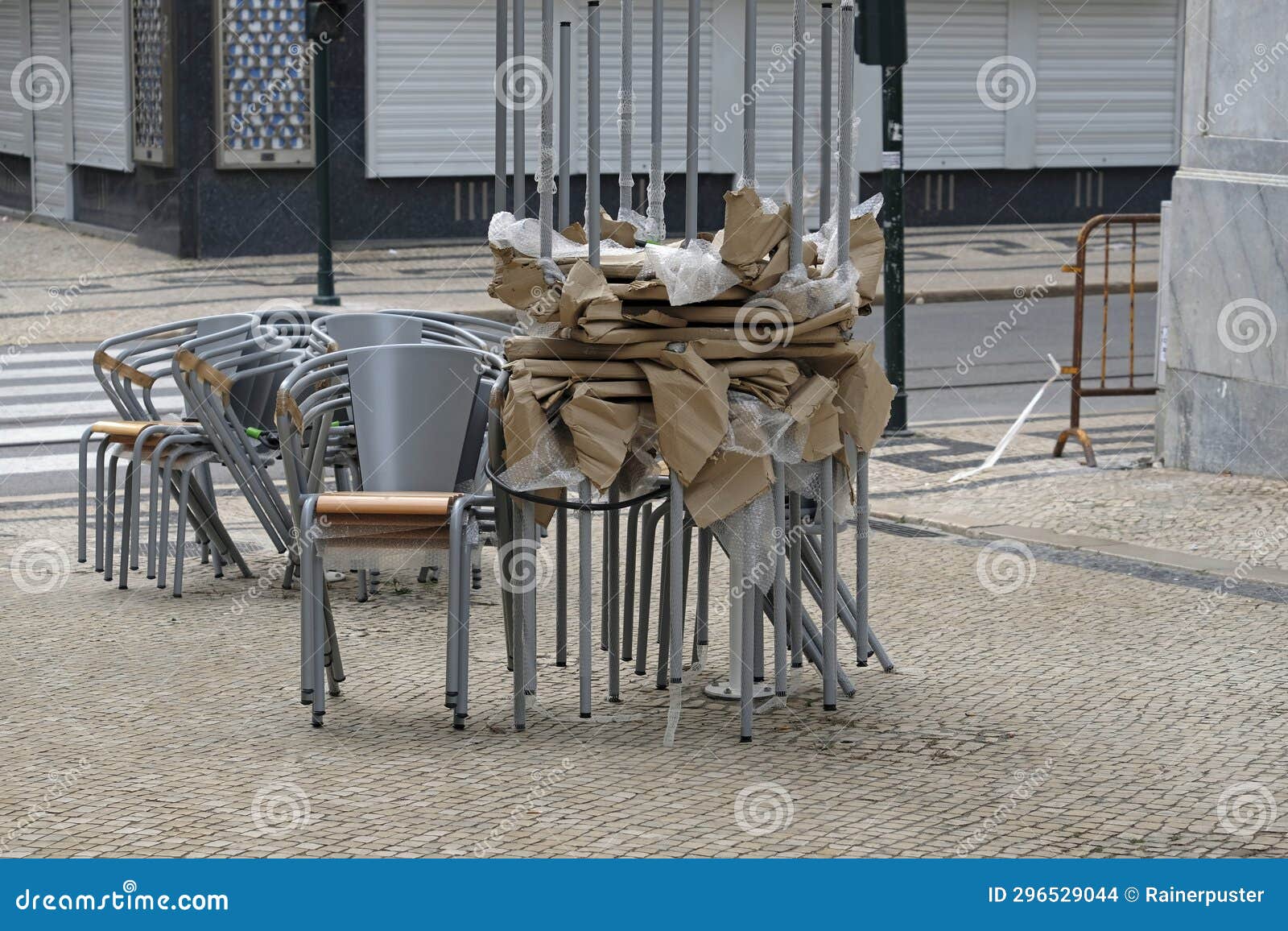 Stacked chairs and tables stock photo. Image of street 296529044