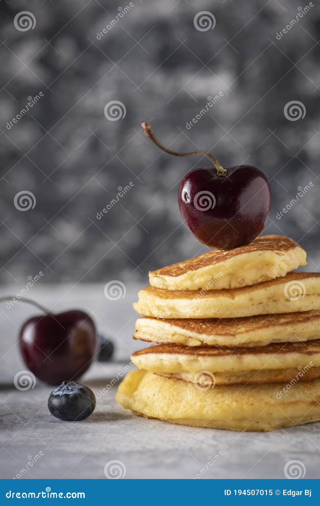 hot cakes with strawberries and cherries seen from close up