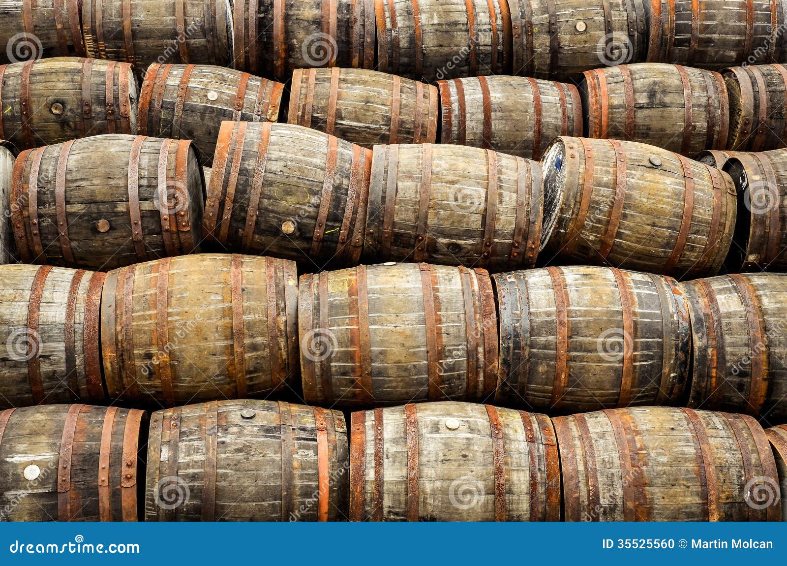stacked pile of old whisky and wine wooden barrels