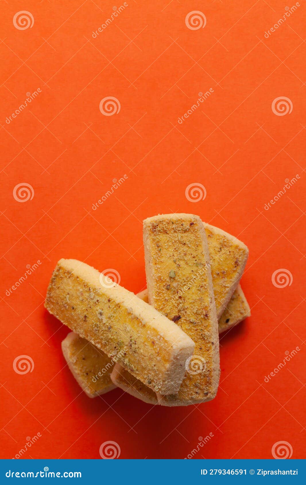 stacked pistachio cookies or butter pista bakery cookies, on orange background.