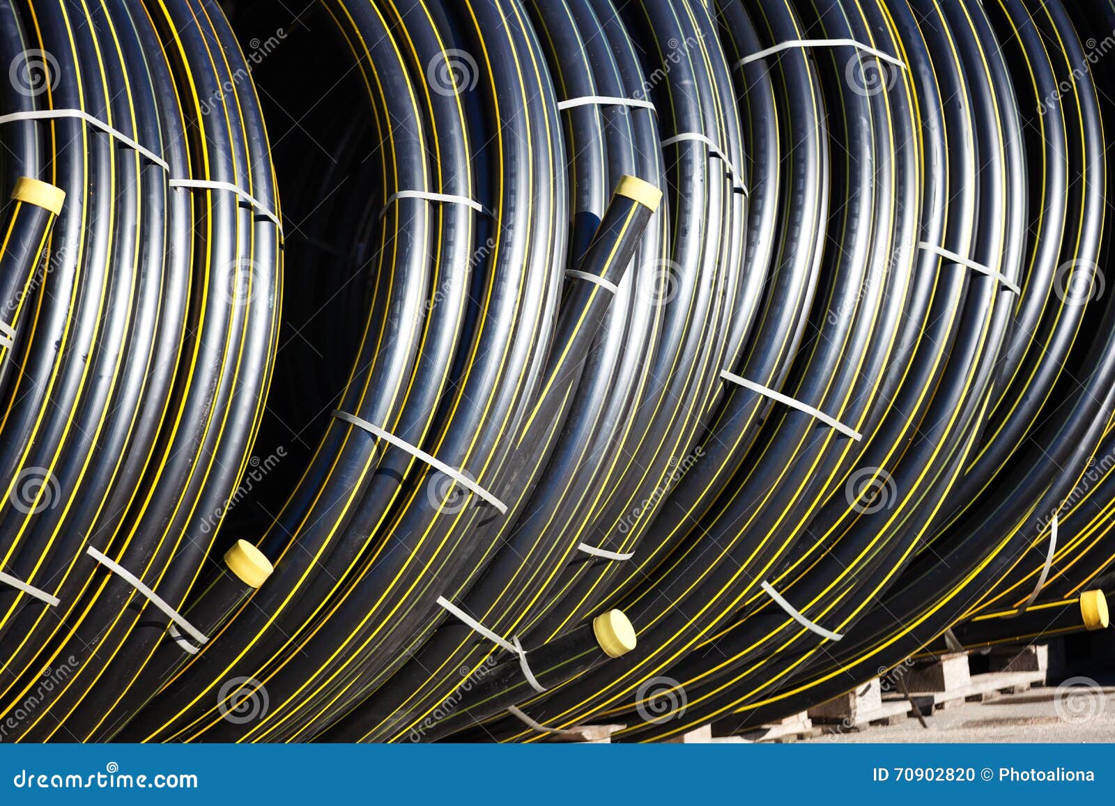 Stacks of Black Pvc Plastic Pipe Outdoors with Selective Focus Stock