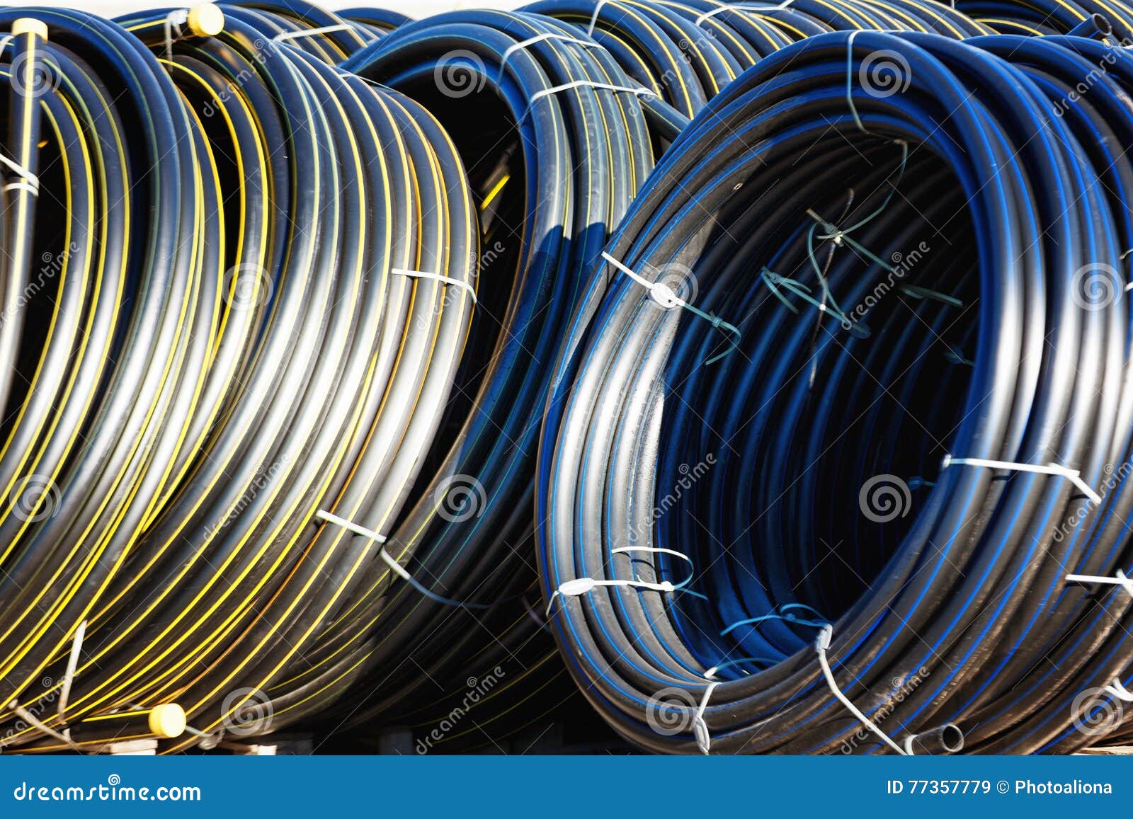 Stacks of Black Pvc Plastic Pipe Outdoors with Selective Focus Stock