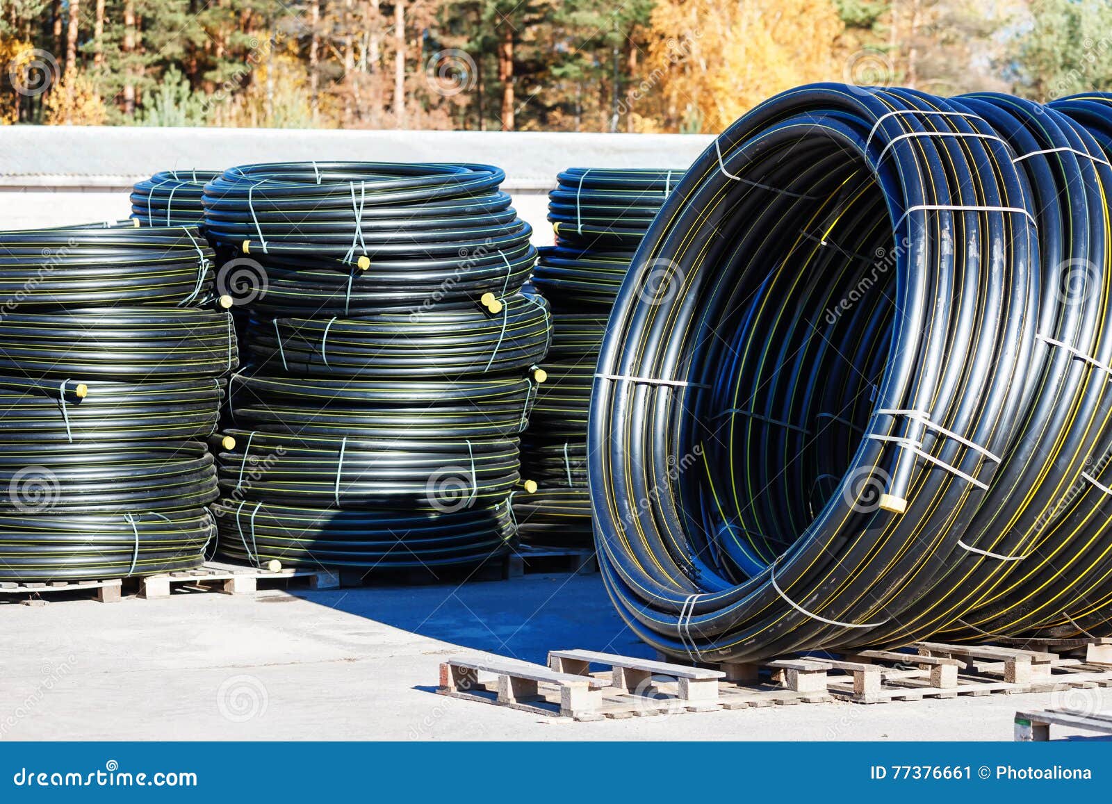 Stacks of Black Pvc Plastic Pipe Outdoors with Selective Focus Stock