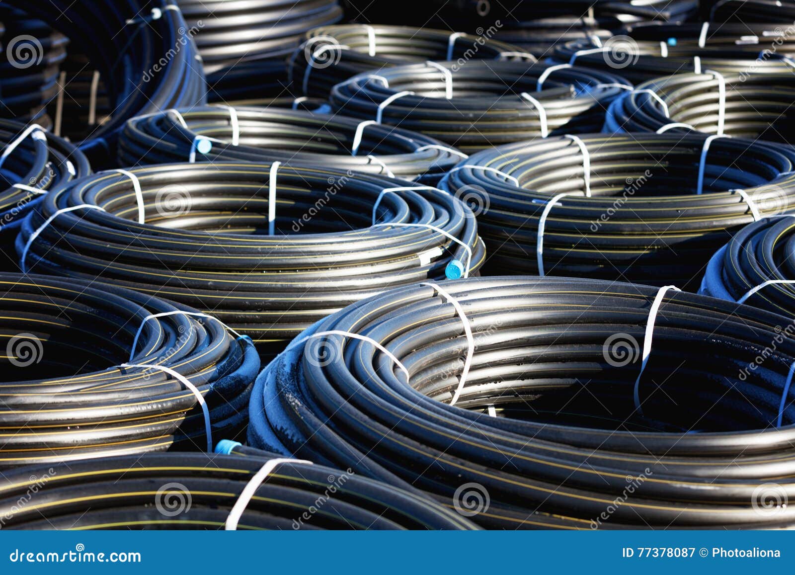 Stacks of Black Pvc Plastic Pipe Outdoors with Selective Focus Stock
