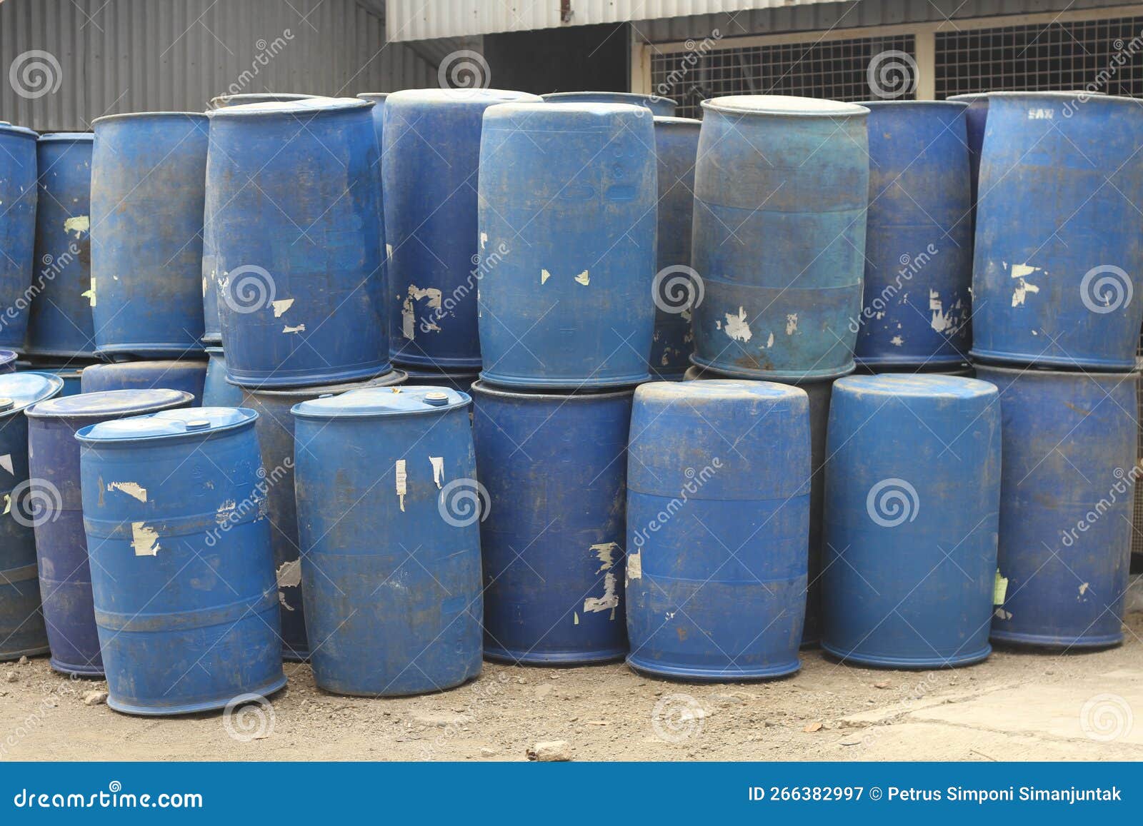 Stacks of Blue Plastic Drums Used for Bulk Storage in a Factory Area