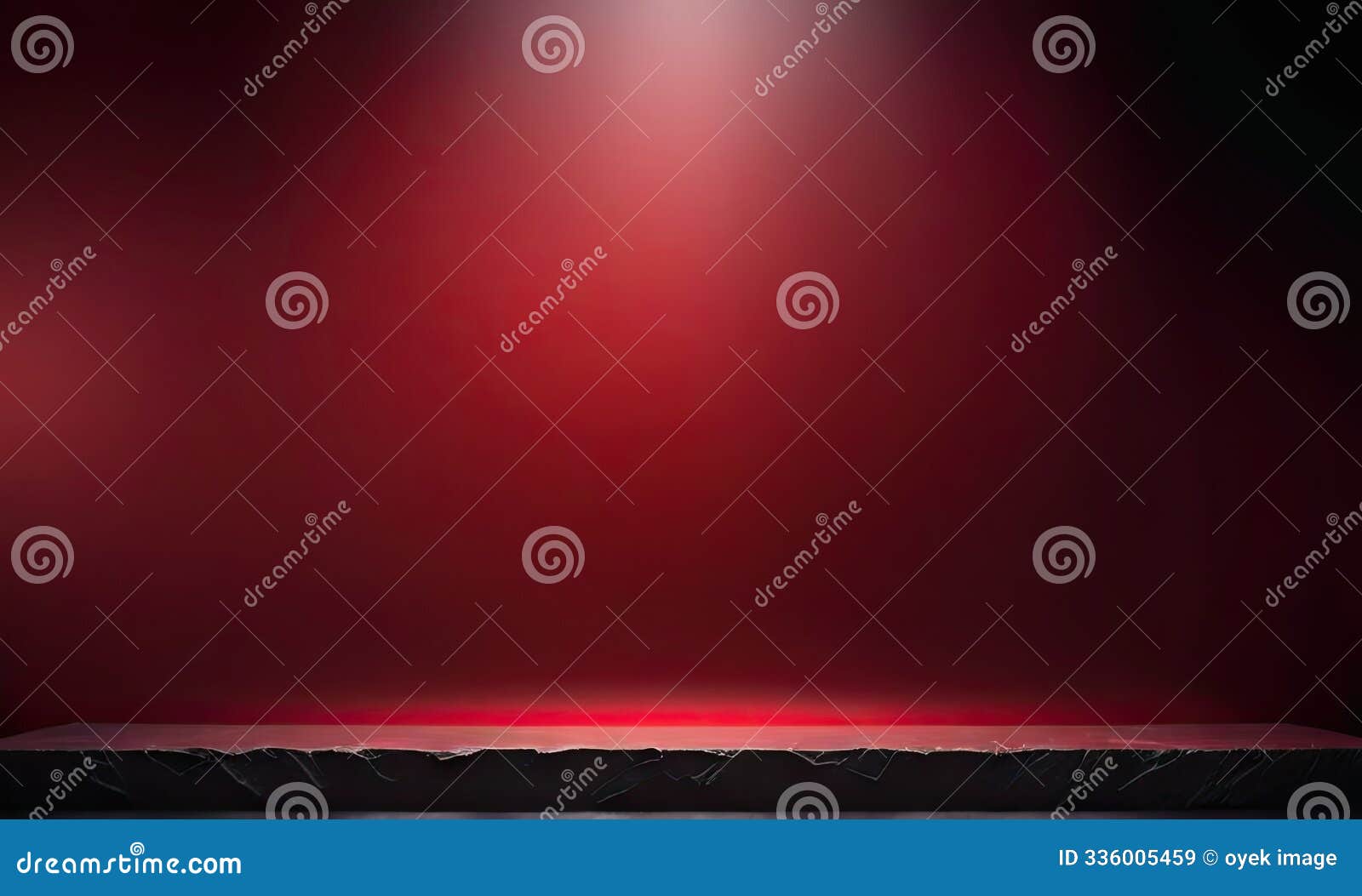 stage with a broad red background, softly lit by overhead lights