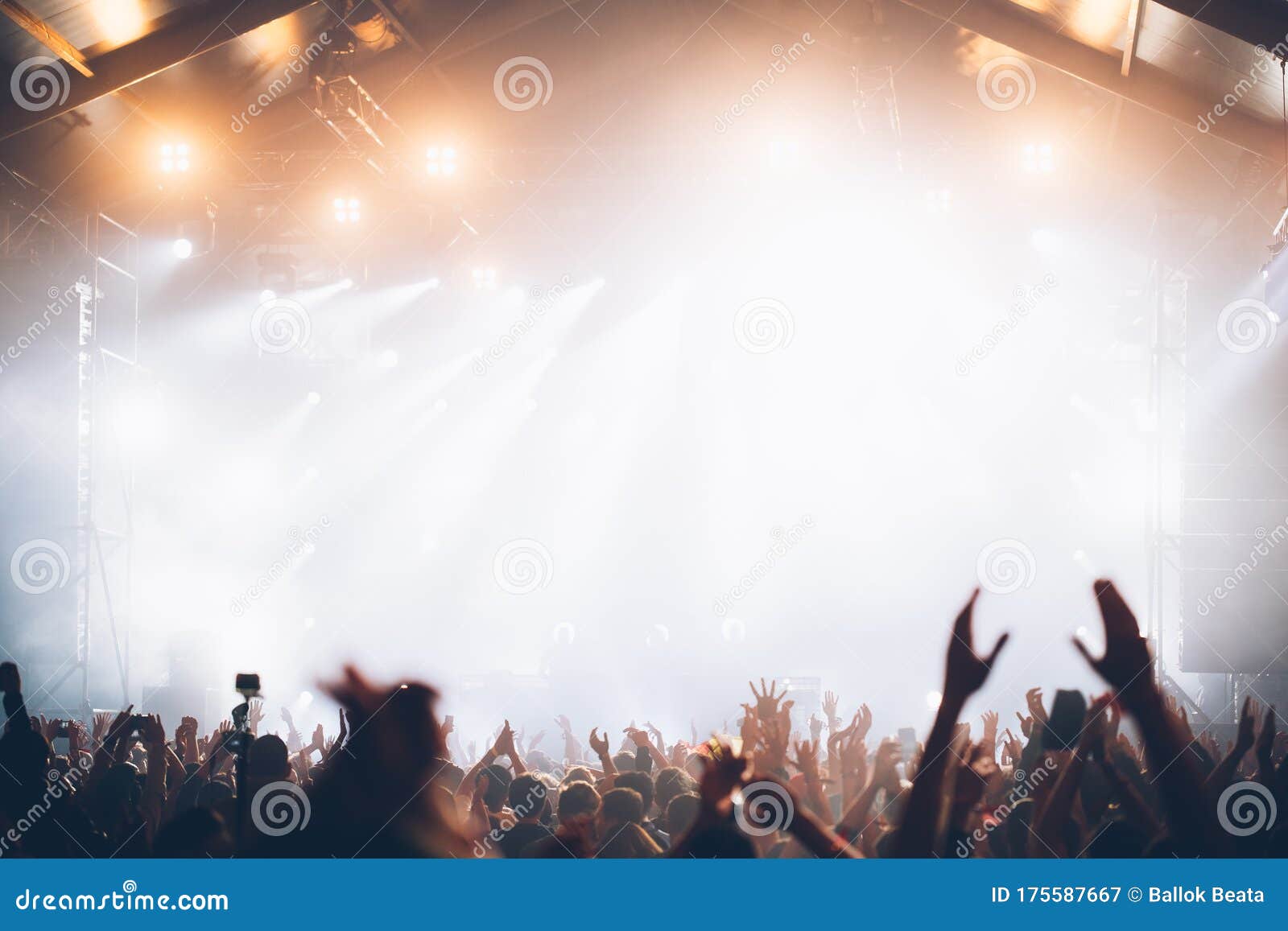 Stage Lights and Crowd of Audience with Hands Raised at a Music ...