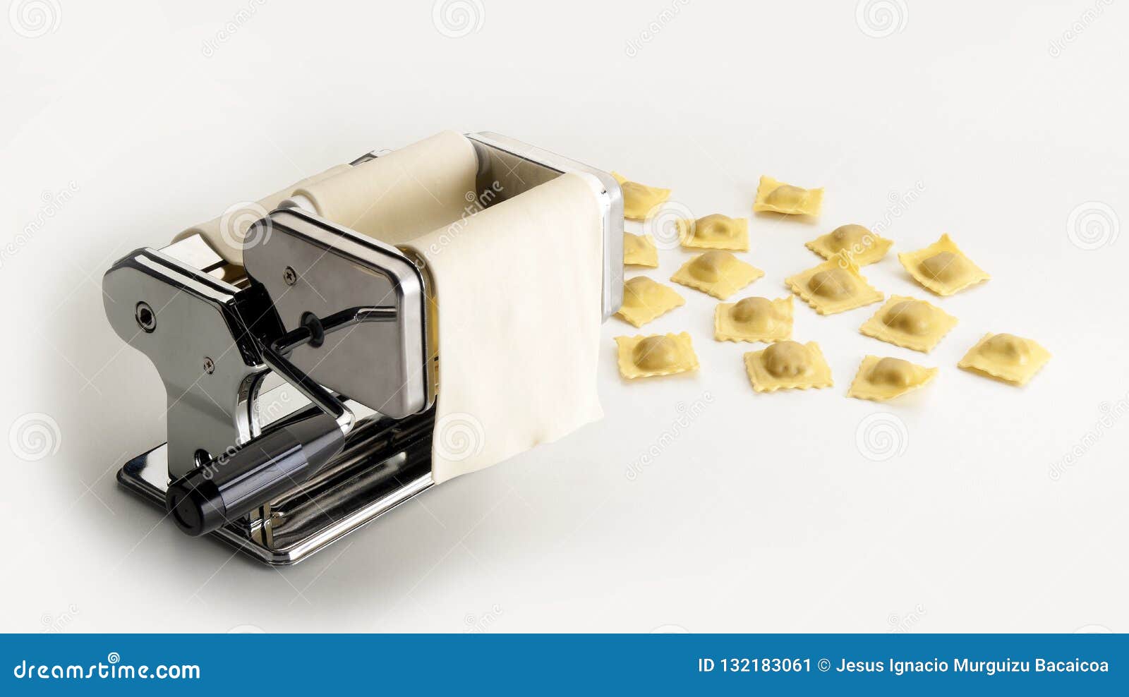 stainless steel machine to flatten, fill and cut italian pasta next to some ravioli samples