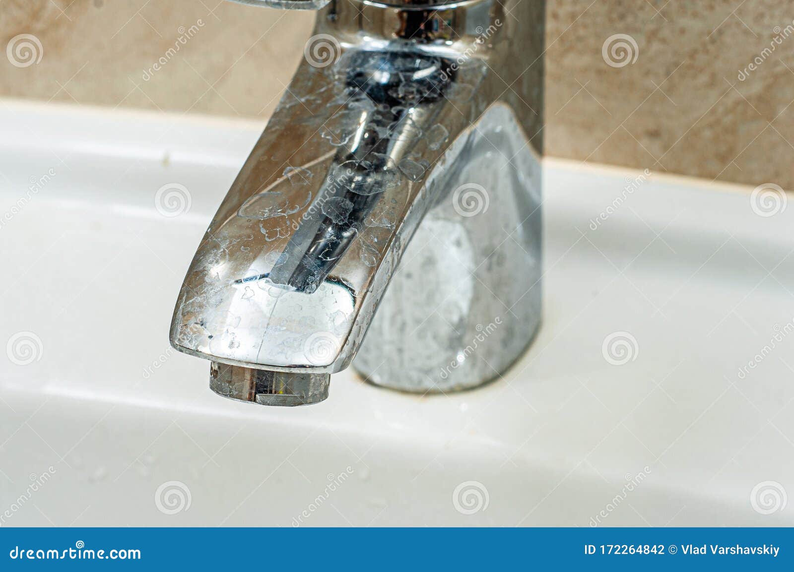 Stains from Hard Water on the Chrome Spout of the Tap. Dirty Sink