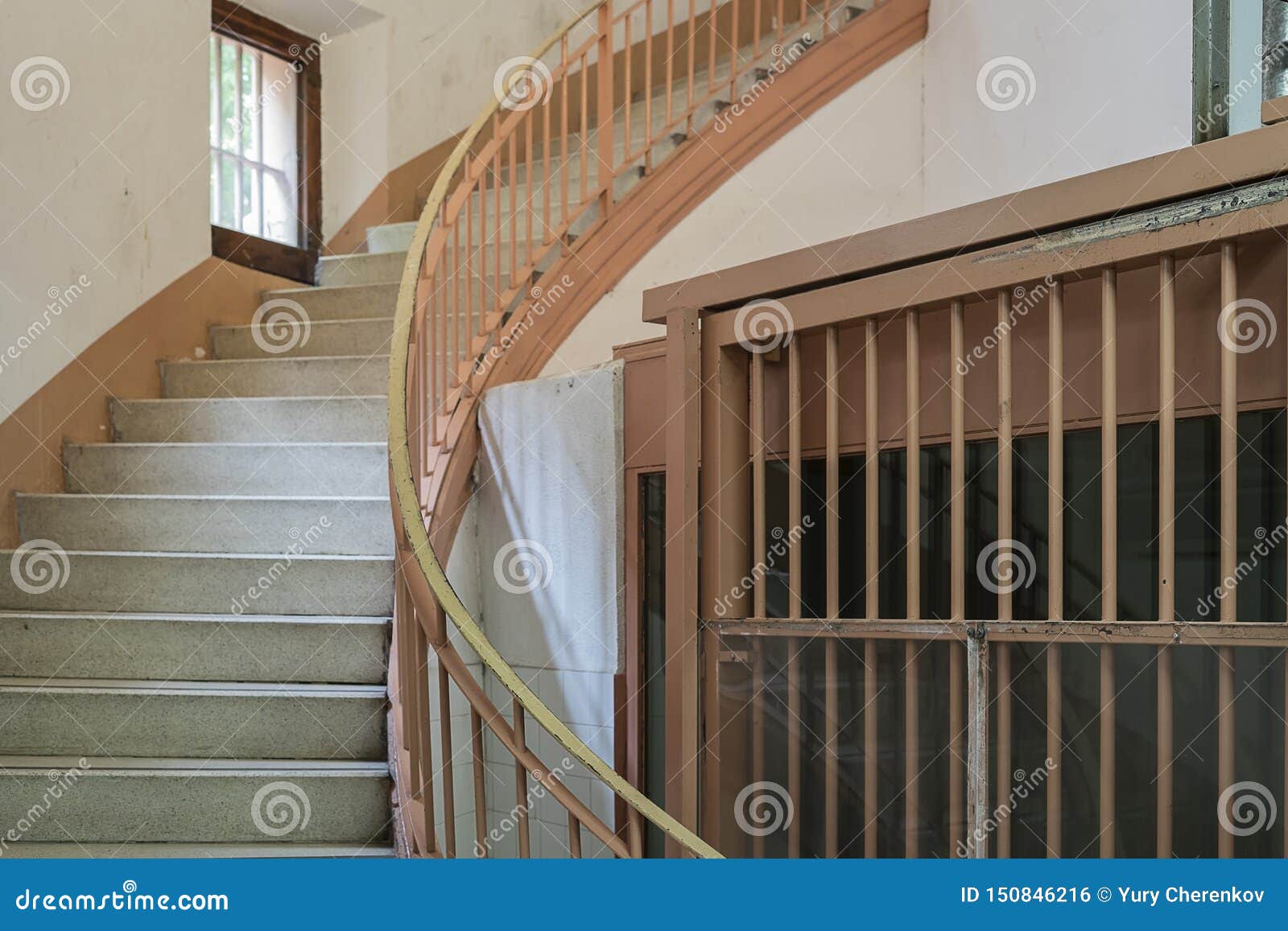 staircase in prison next to a lattice window
