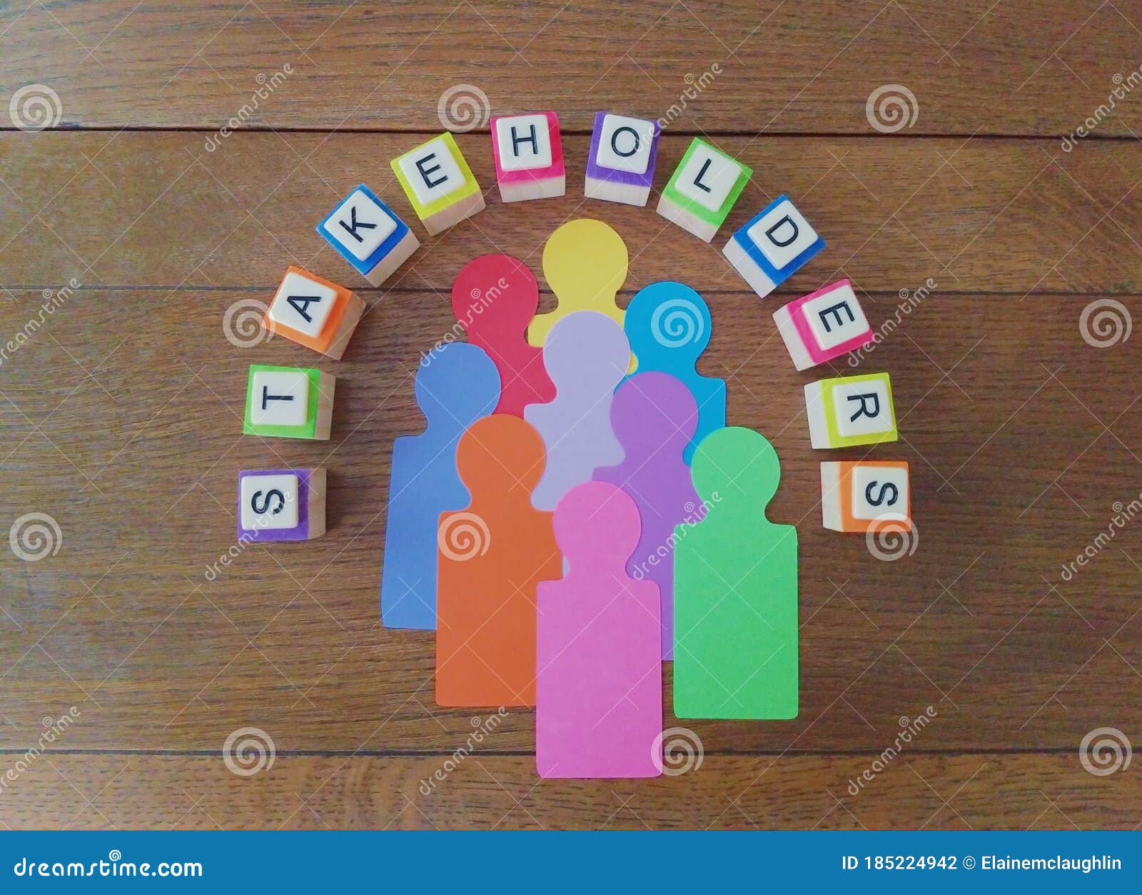 stakeholders concept with multiple representatives and colorful text on wood background.