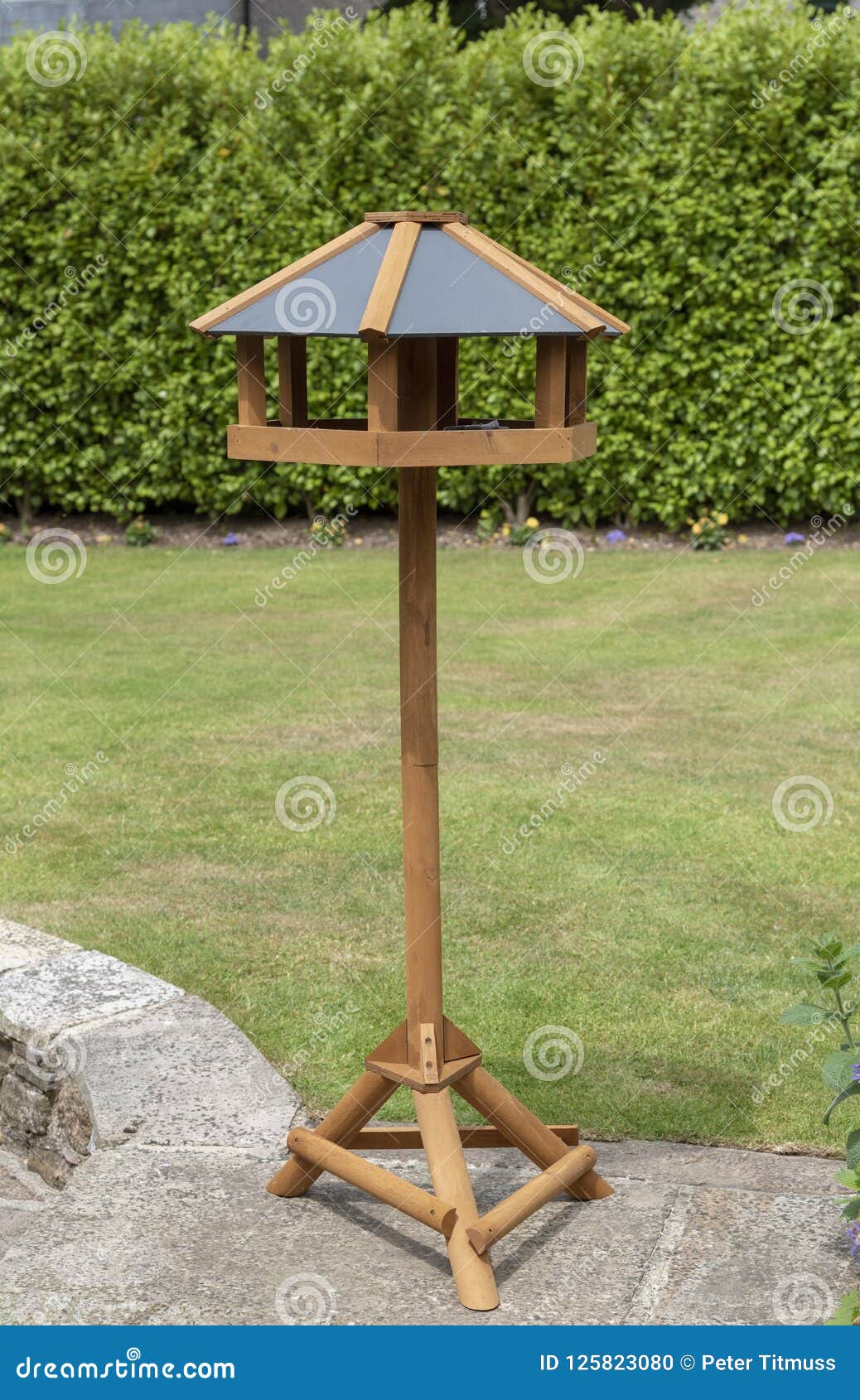 Wooden Bird Feeder Standing On A Garden Patio Stock Photo ...