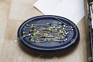 Stand With Pins With Multi colored Heads On A Wooden Surface Stock Stand With Pins With Multi colored Heads On A Wooden Surface Stock
