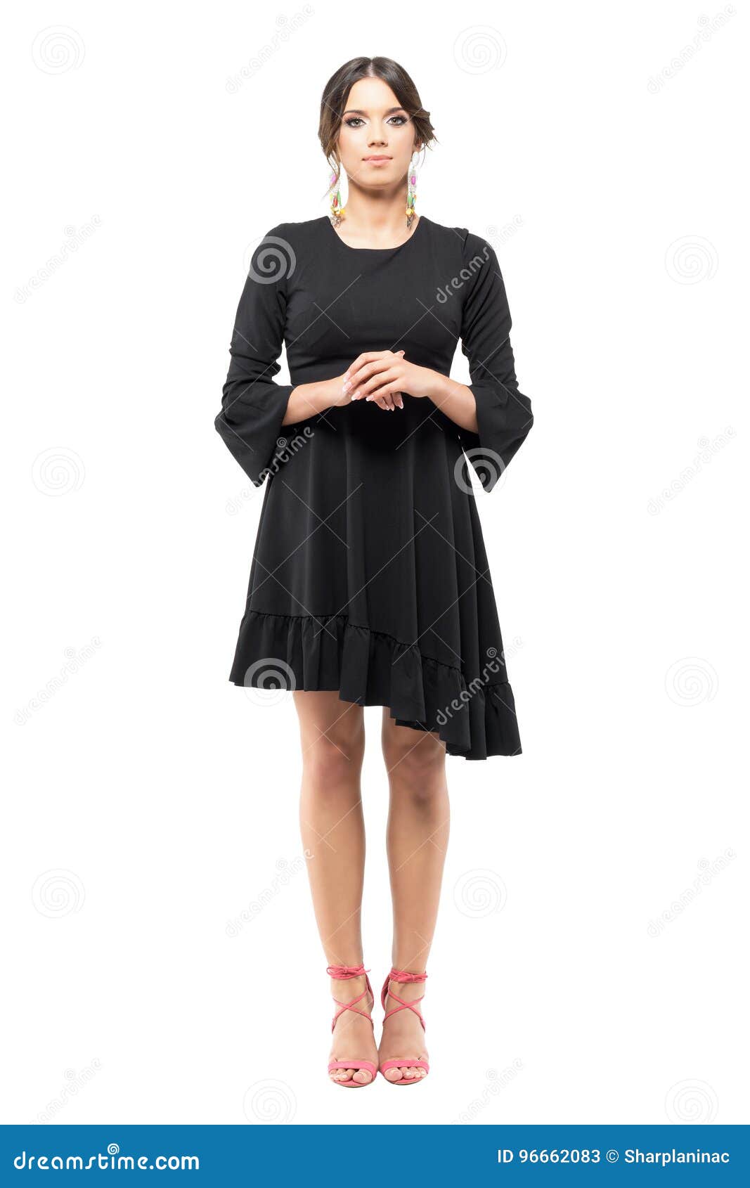 Standing Classy Formal Woman In Black Dress With Hand Clasped Looking At Camera Stock Image 