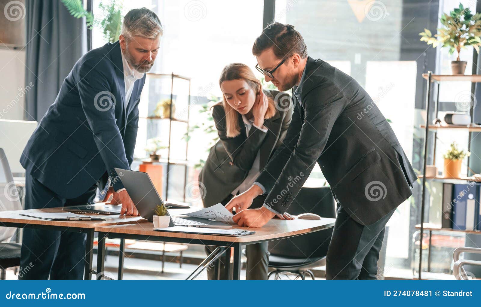 Standing by the Table. Group of Business People are Working in the