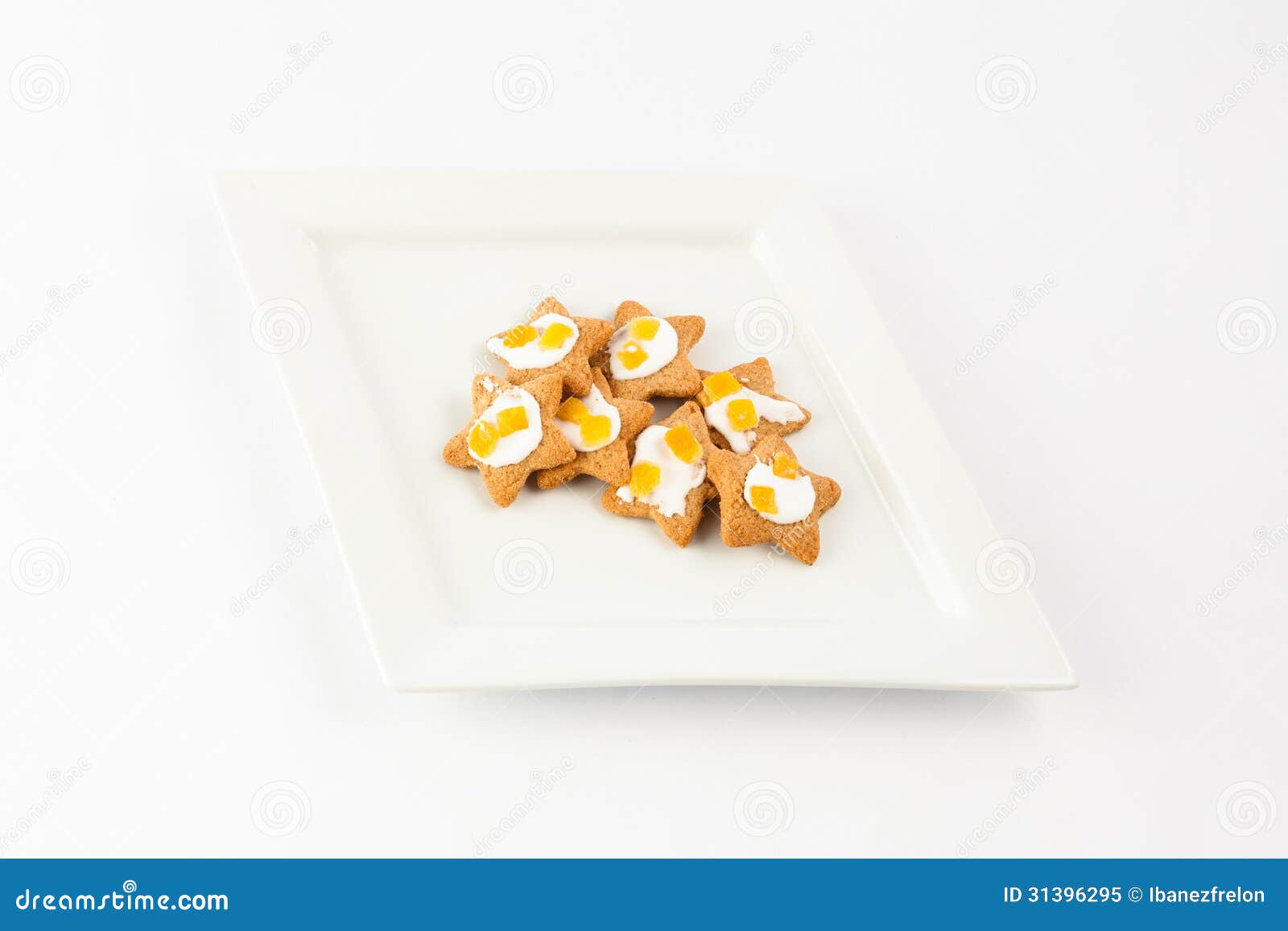 Savor the simplicity of these delightful star-shaped biscuits artfully arranged on a plate. Enjoy a moment of sweetness perfect for tea time or any cozy occasion. These homemade treats are a charming addition to your snack repertoire. Plate of decorative star shaped biscuits on plate with white background.