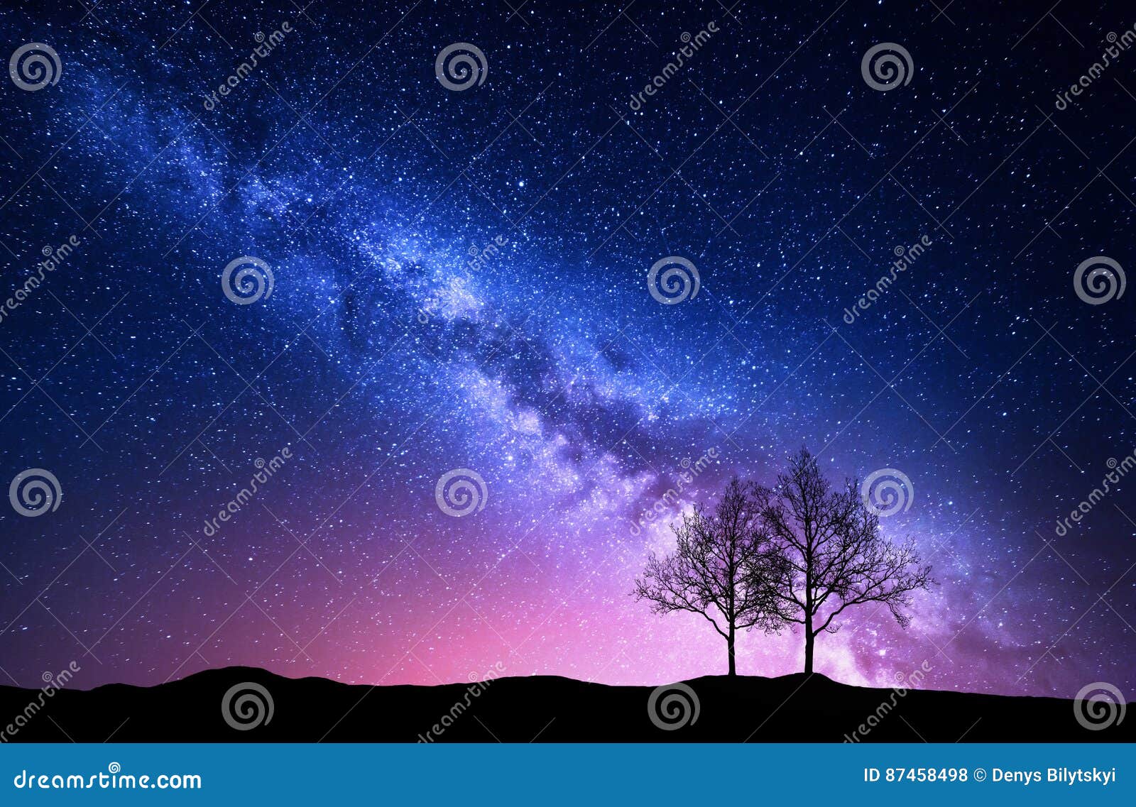starry sky with pink milky way and trees. night landscape