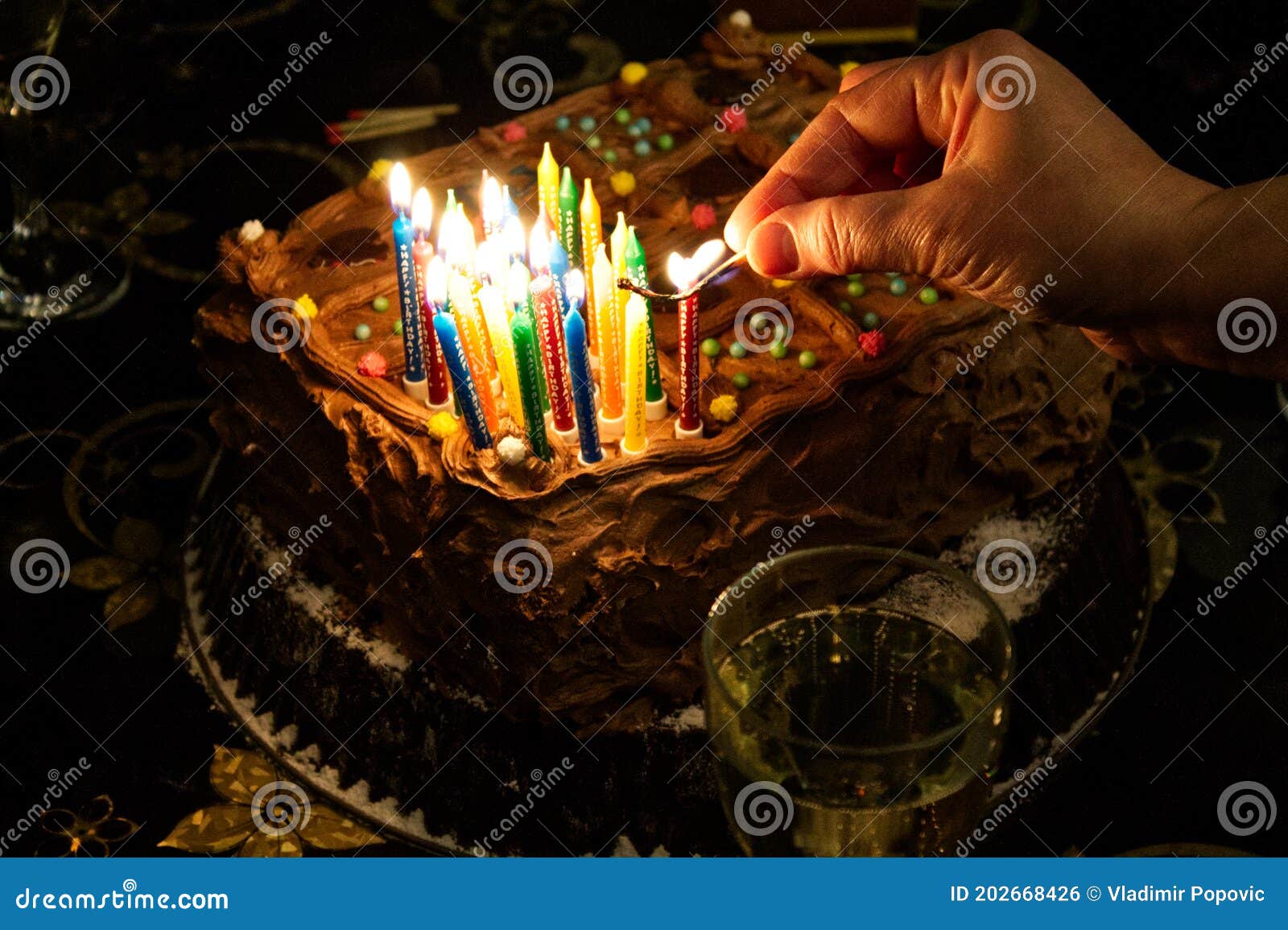 Start Lighting Candles on a Birthday Chocolate Cake Stock Photo Image
