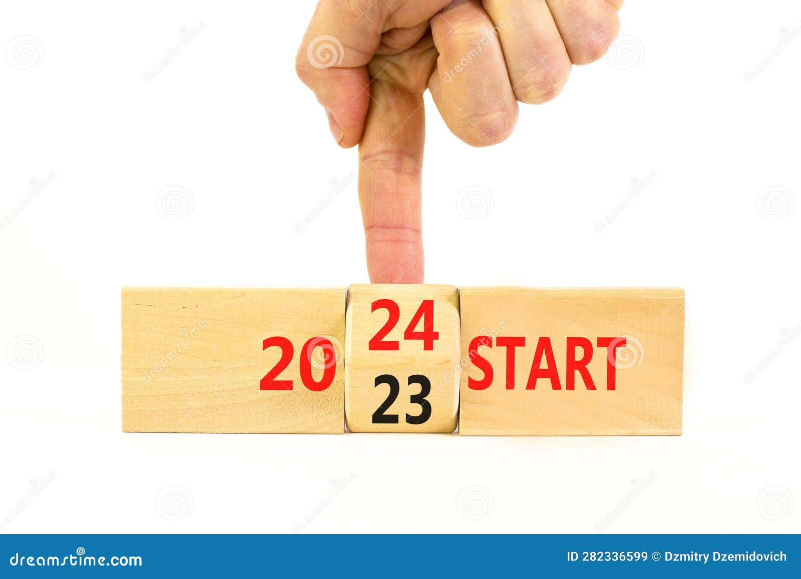 2024 Start New Year Symbol. Businessman Turns a Wooden Cube and Changes