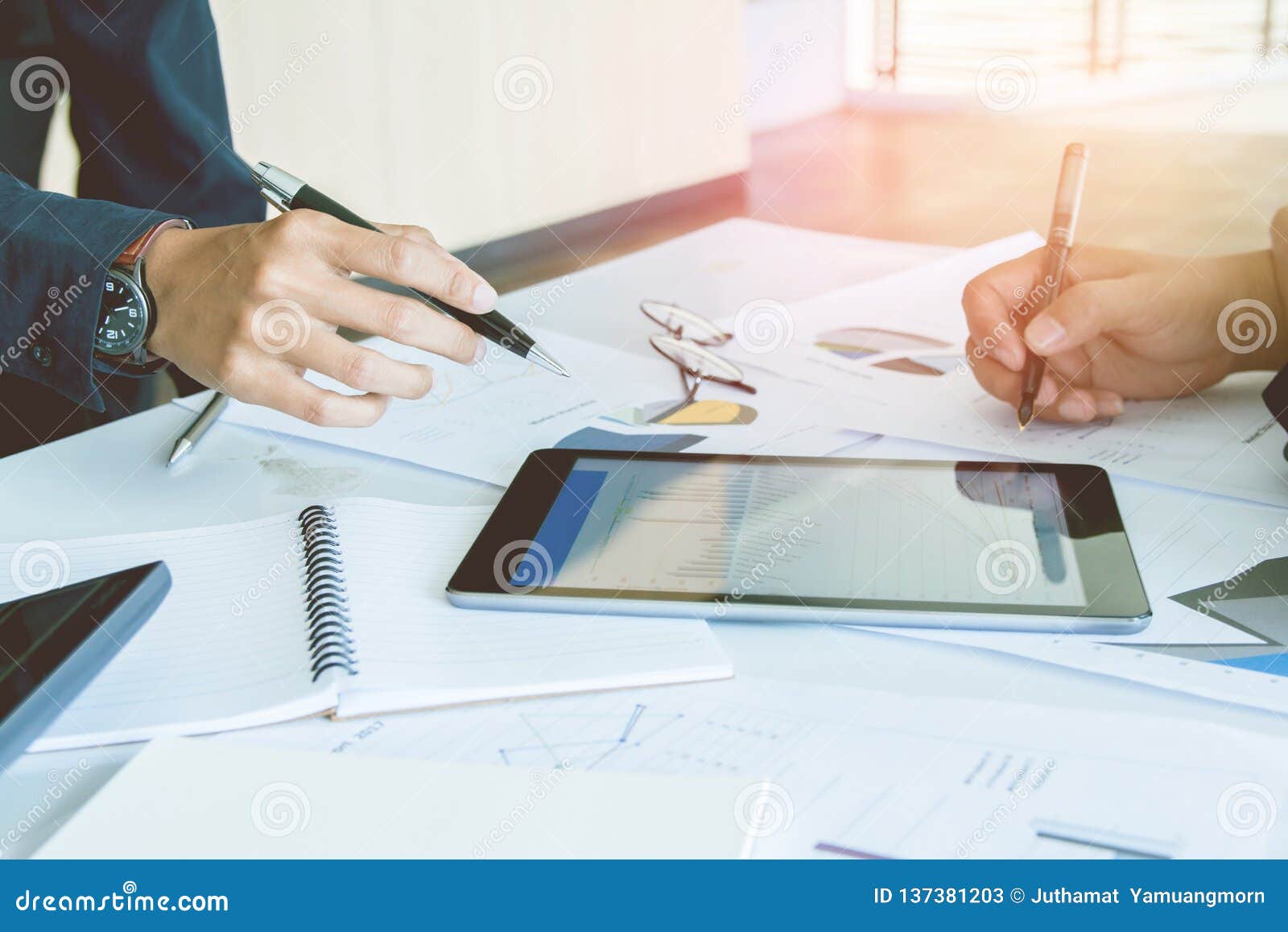 start up business. people team work meeting point to discuss the graph up and down of economy and work on tablet