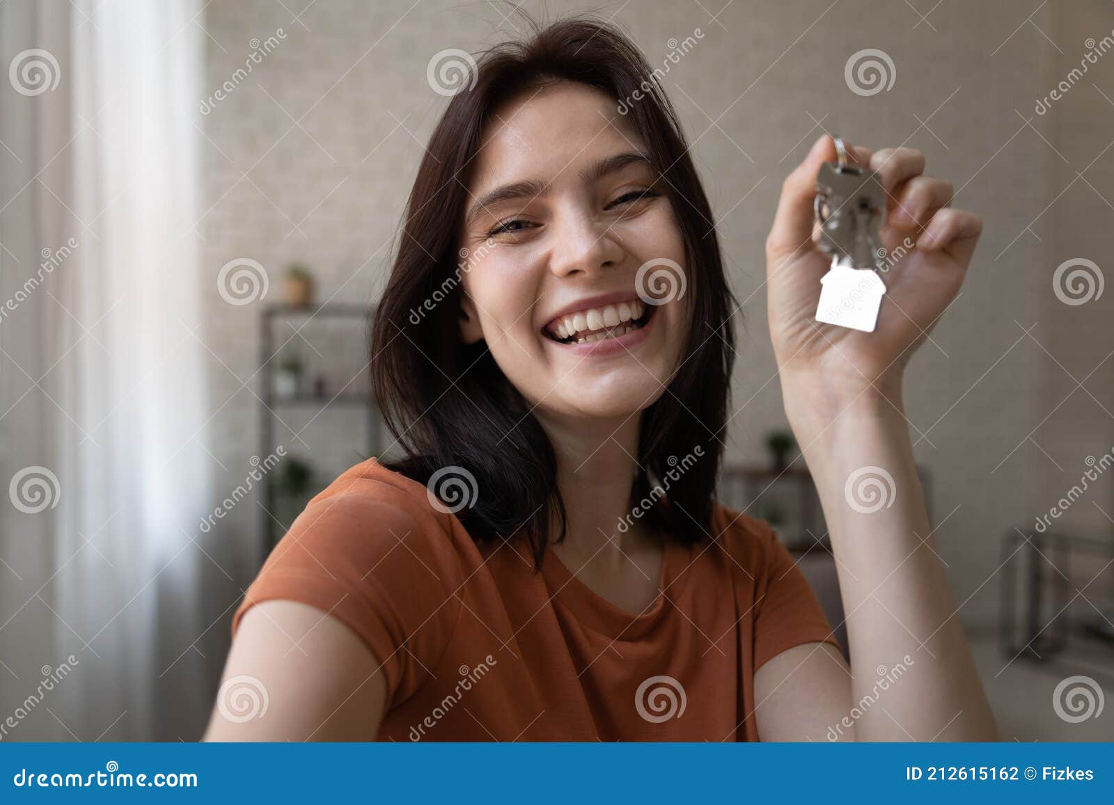 overjoyed young female shoot selfie holding keys from new home