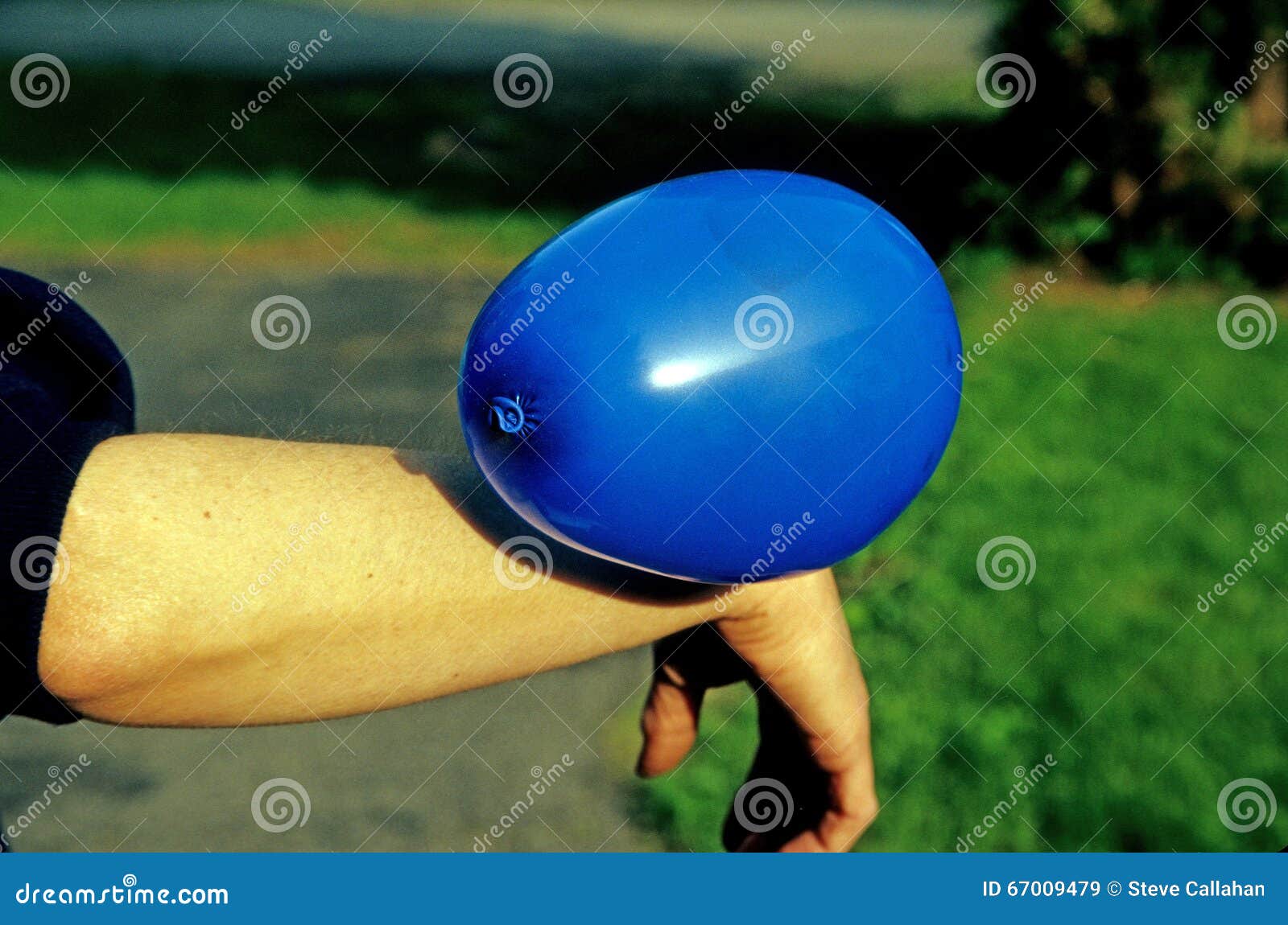 static electricity shown by balloon attached to female arm
