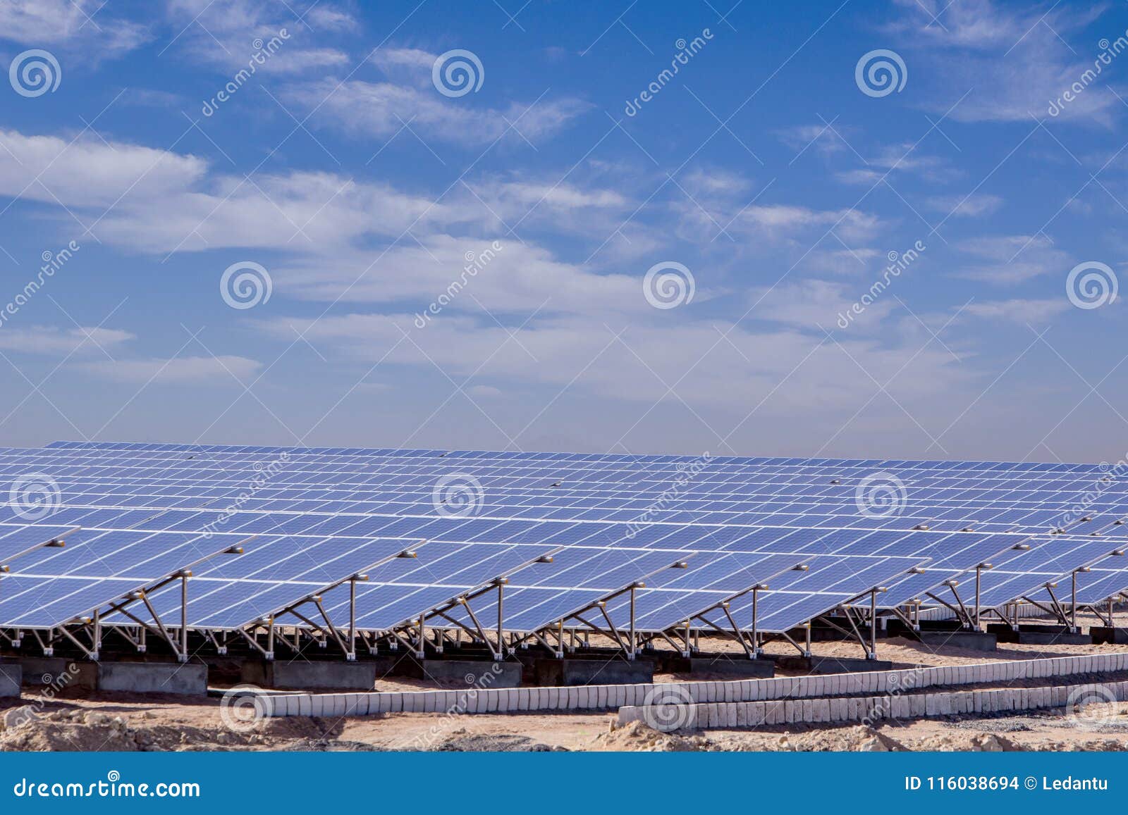 station of solar panels in the desert against blue sky