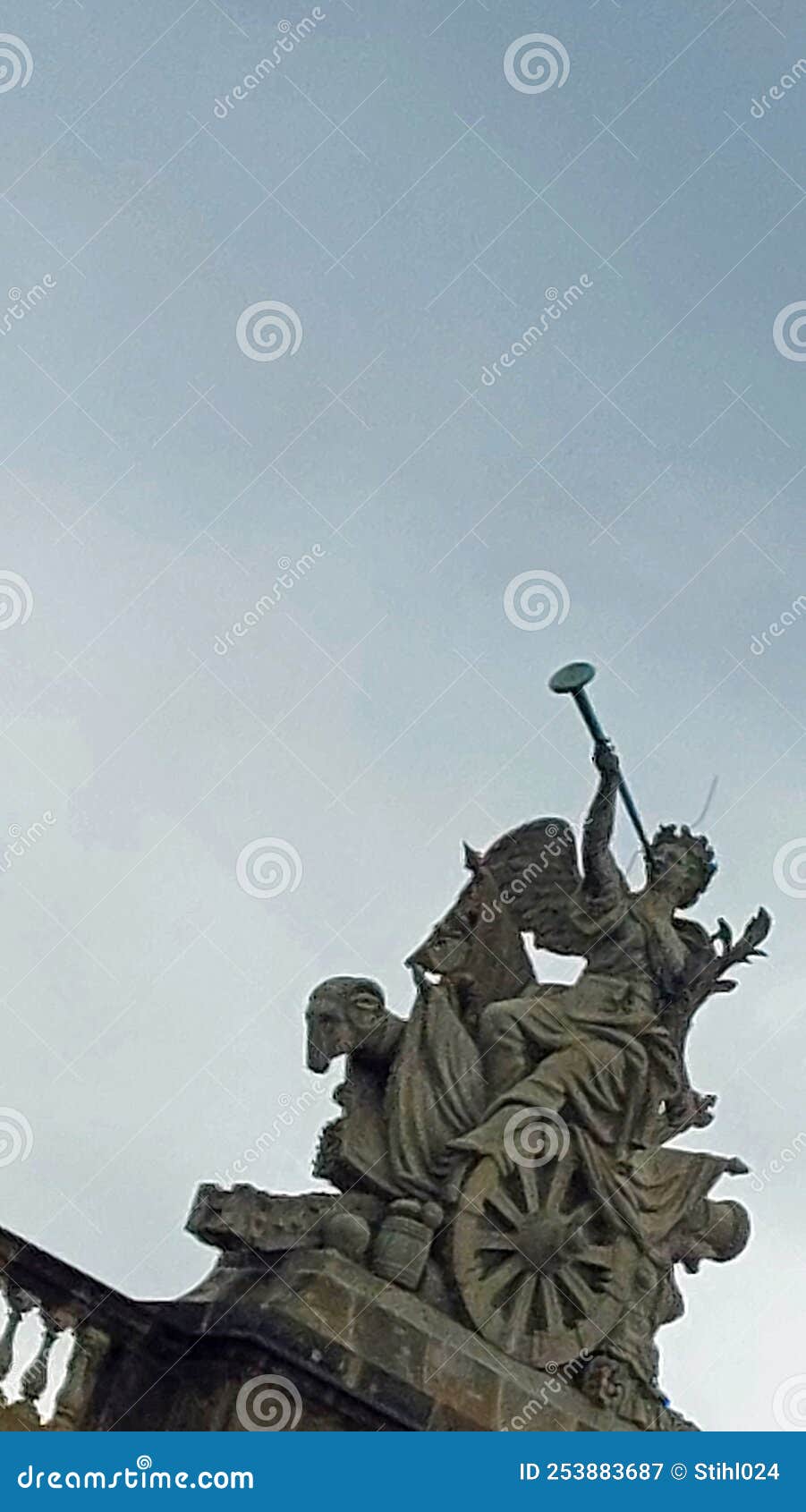 statue with angel sounding trumpet on chariot