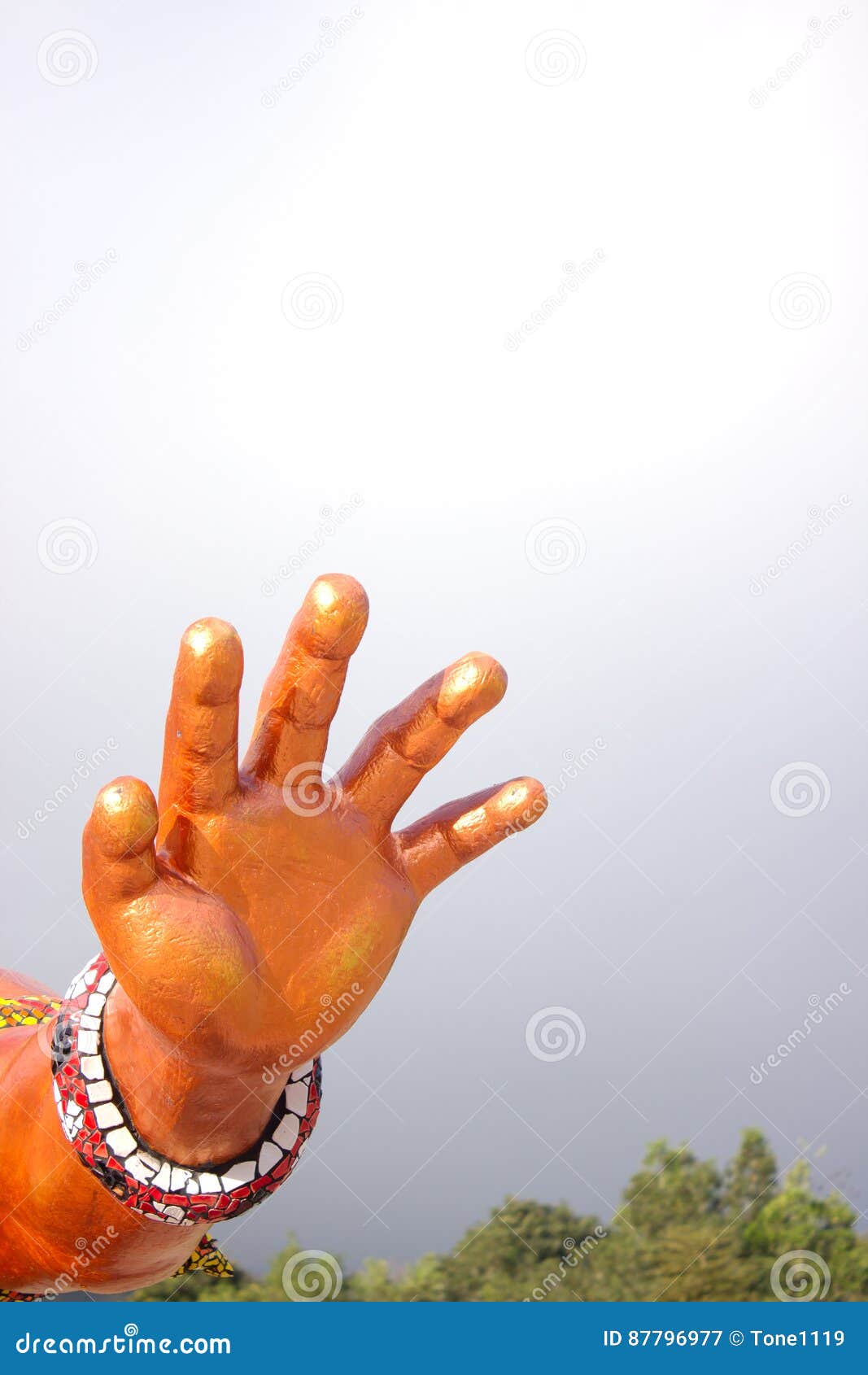 Statue with Arm and Hand Extended Upward on a Nature Background Stock