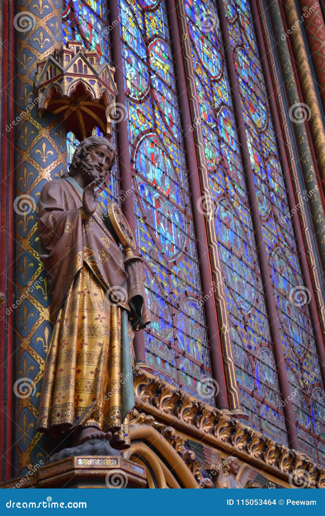 Statue And Beautiful Stained Glass Windows In The Upper