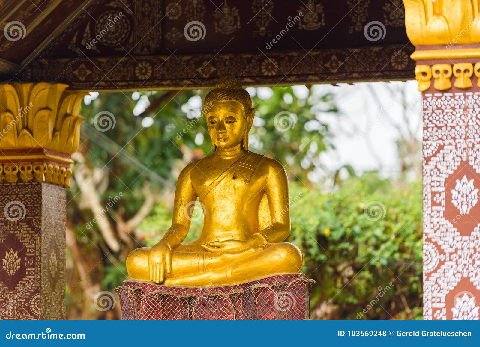 statue of a buddhist god, louangphabang, laos. copy space for text.