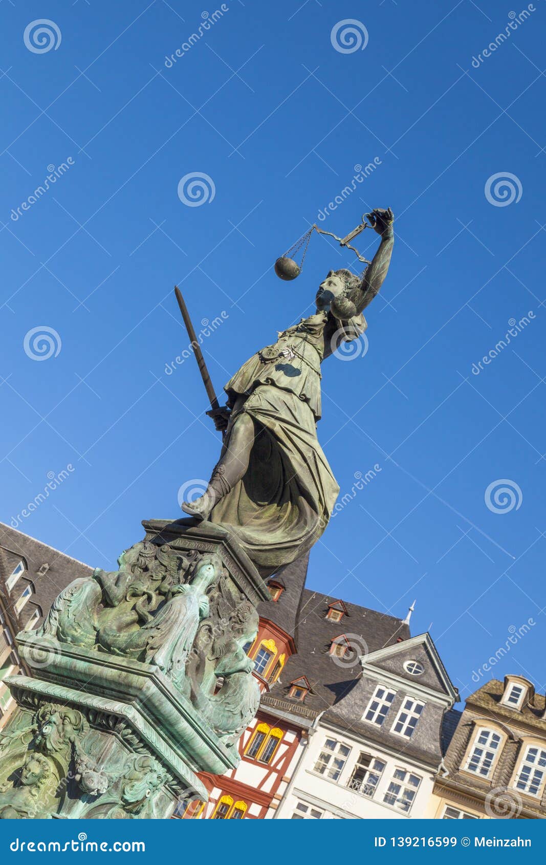 statue of lady justice in front of the romer in frankfurt