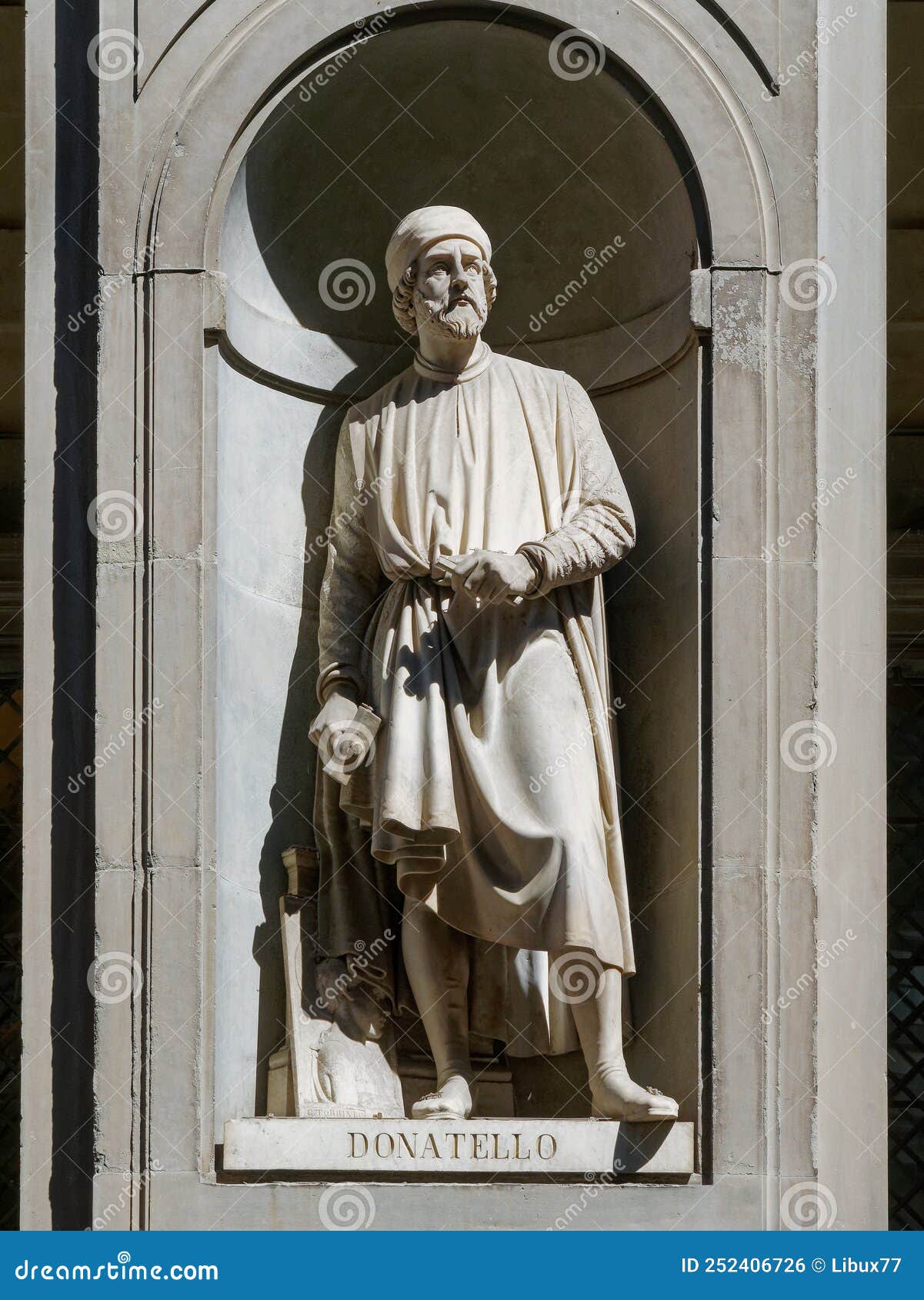 the statue of leonardo da vinci outside the uffizi colonnade in florence. sculpted by luigi pampaloni, 1842