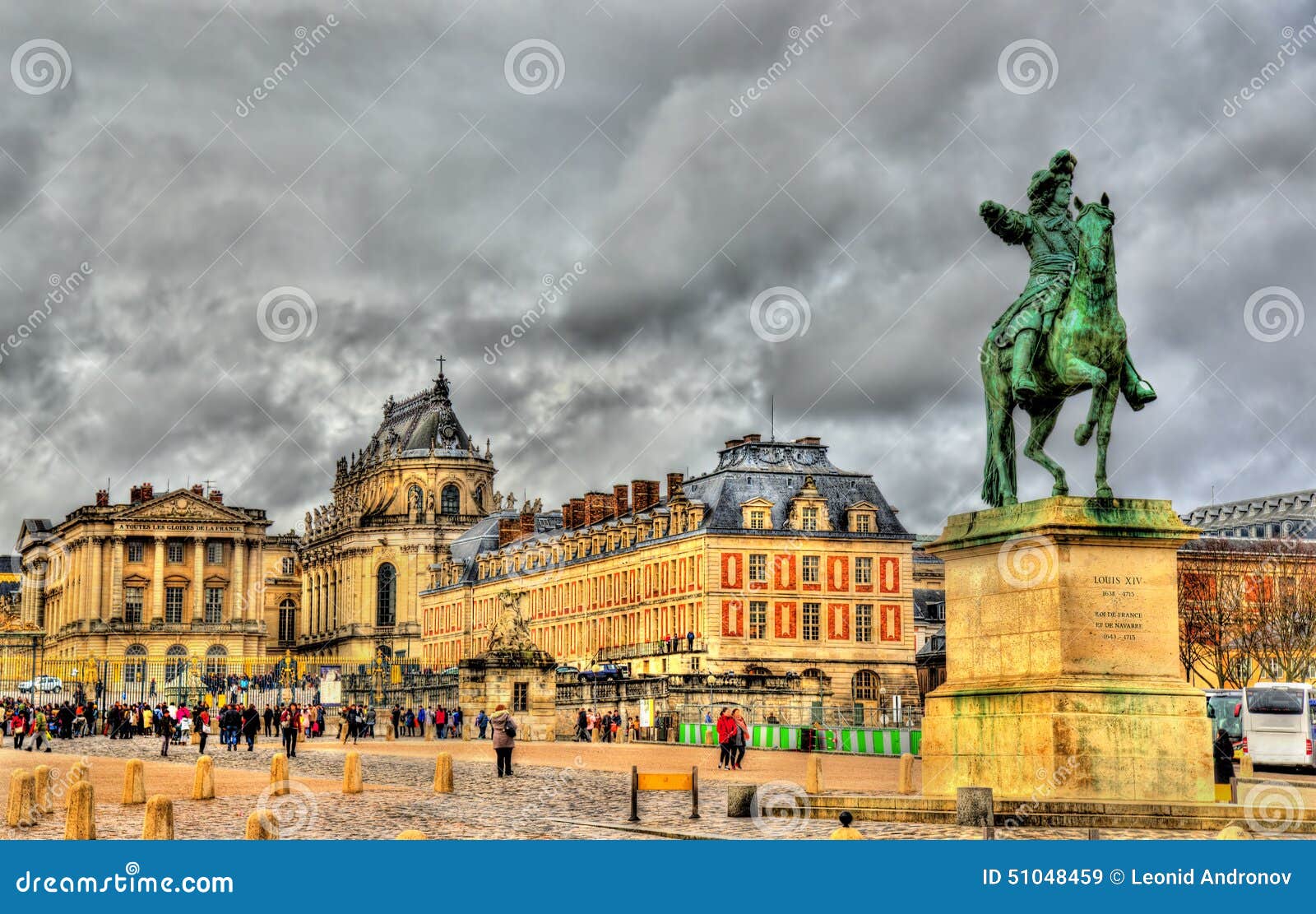 statue of louis xiv in front of the palace of versailles